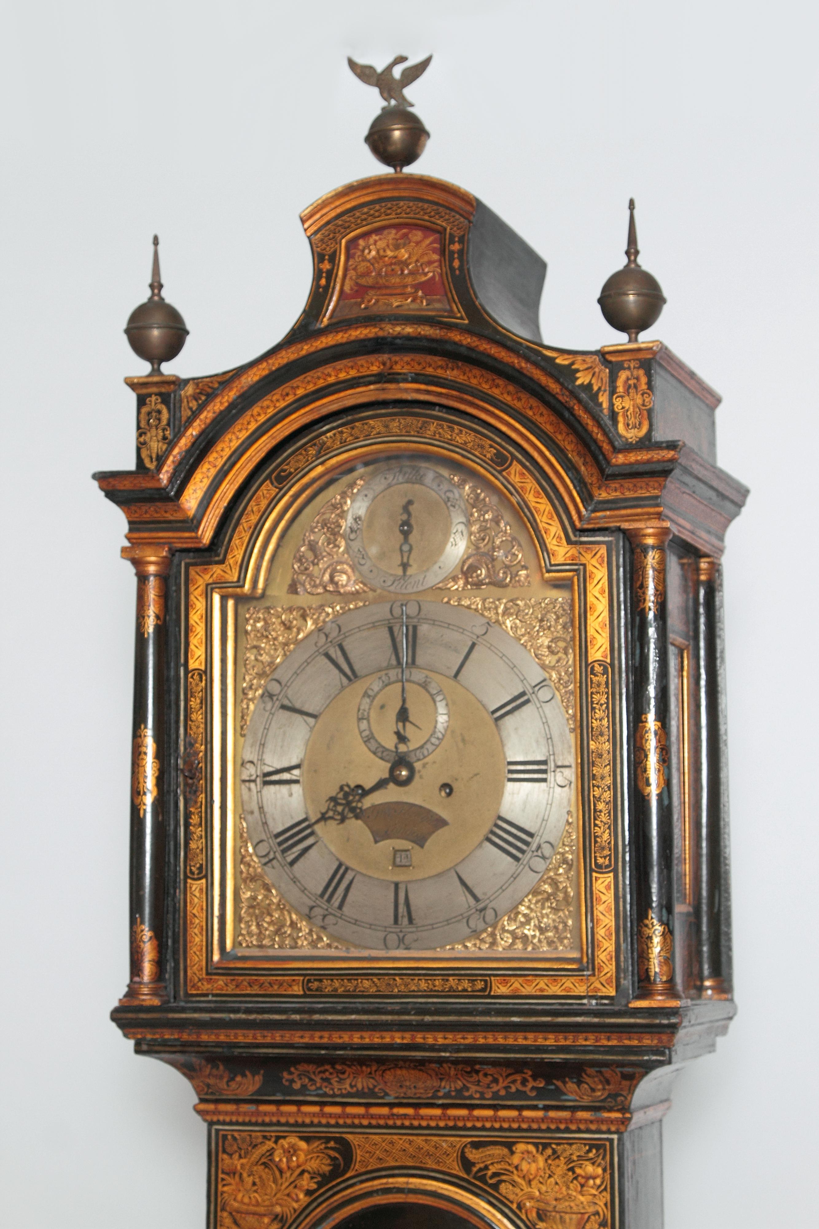 George II lacquered chinoiserie tall case clock inscribed Jno. Fladgate, London. The arched hood with pagoda top surmounted by three brass ball finials, the center finial with an eagle. Sides of hood have glass panels revealing the works inside. The