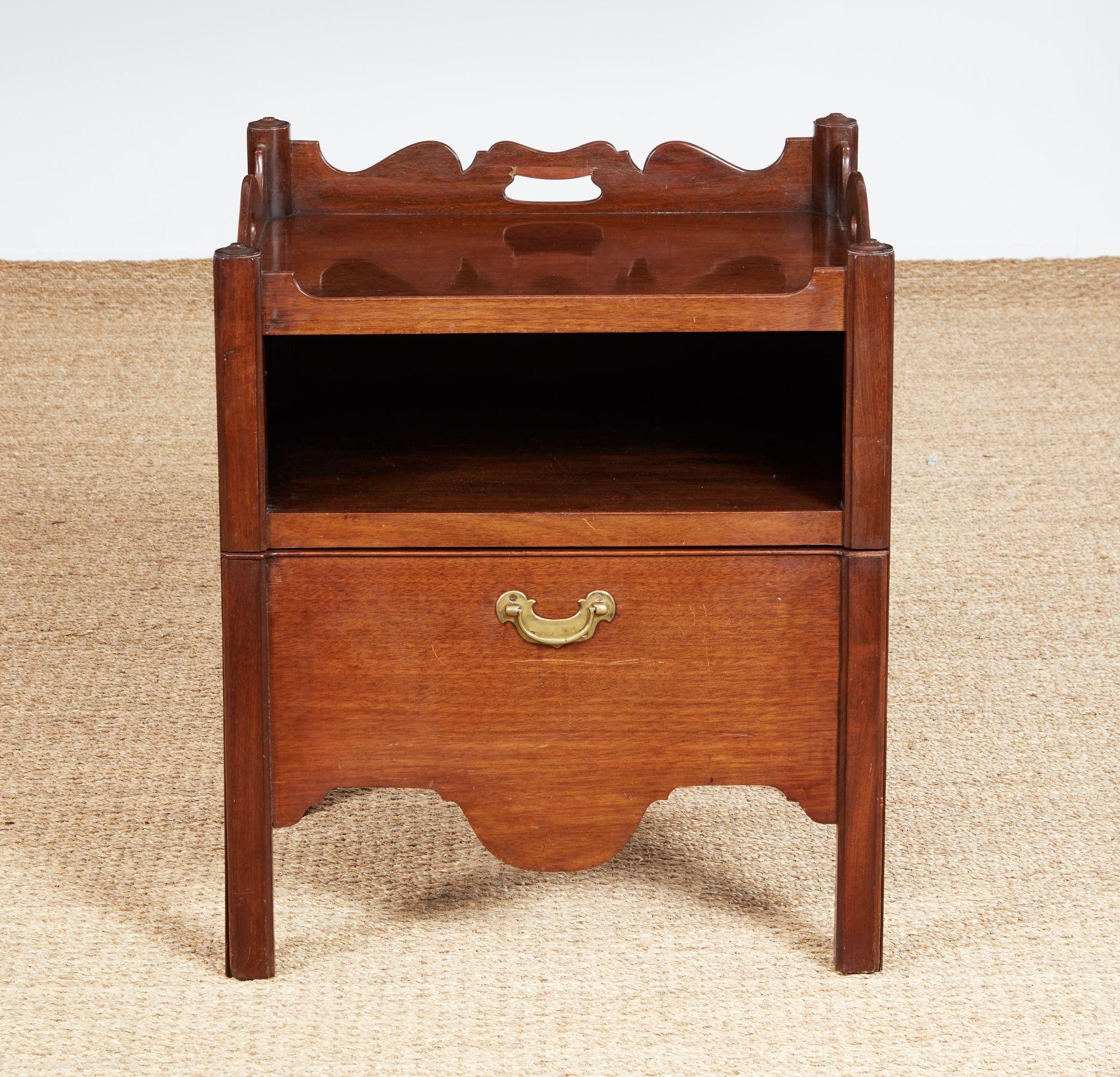 Fine George II mahogany bedside cabinet having scalloped top with hand hold cut outs, over open shelf above pull-out platform now with leather lining, over scalloped apron and standing on square legs, the whole with pleasing color and patina.