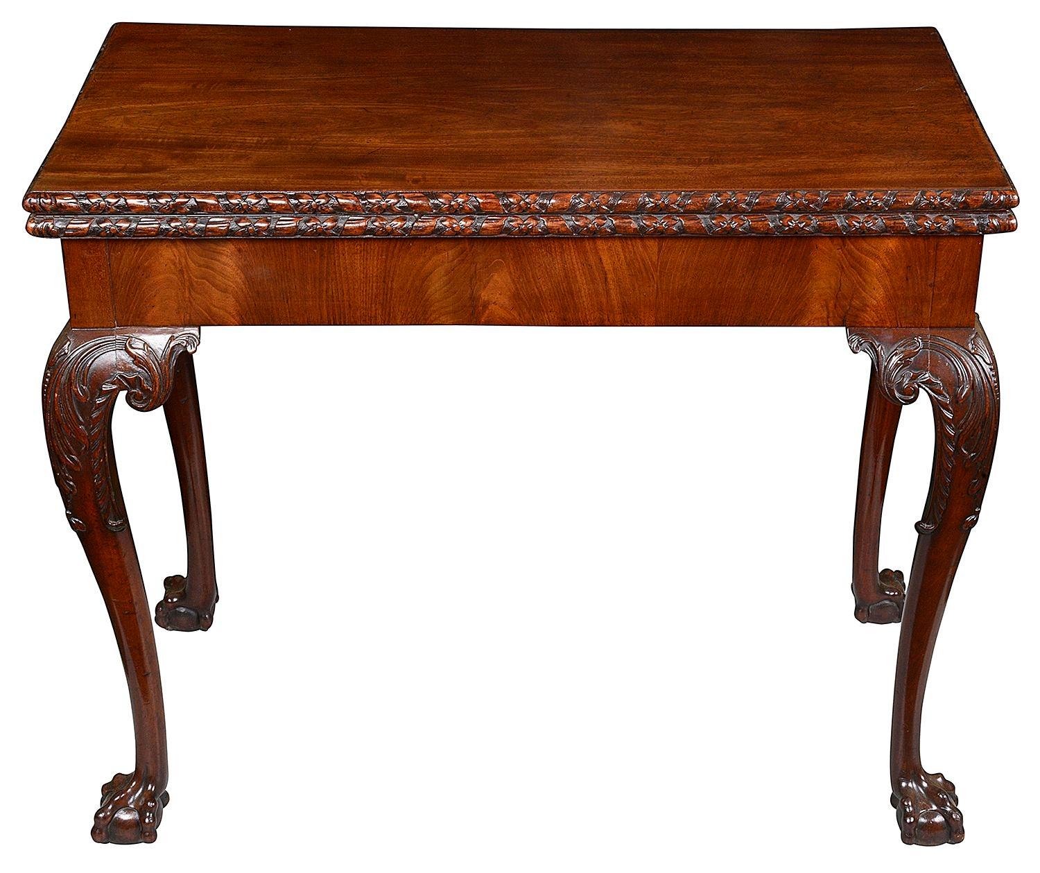 A very good quality Chippendale influenced, 18th Century George II Mahogany Card table, having hand carved ribbon and floral moulding to the edge. The top opening to reveal a baize covered card playing surface, supported by the back legs hinging
