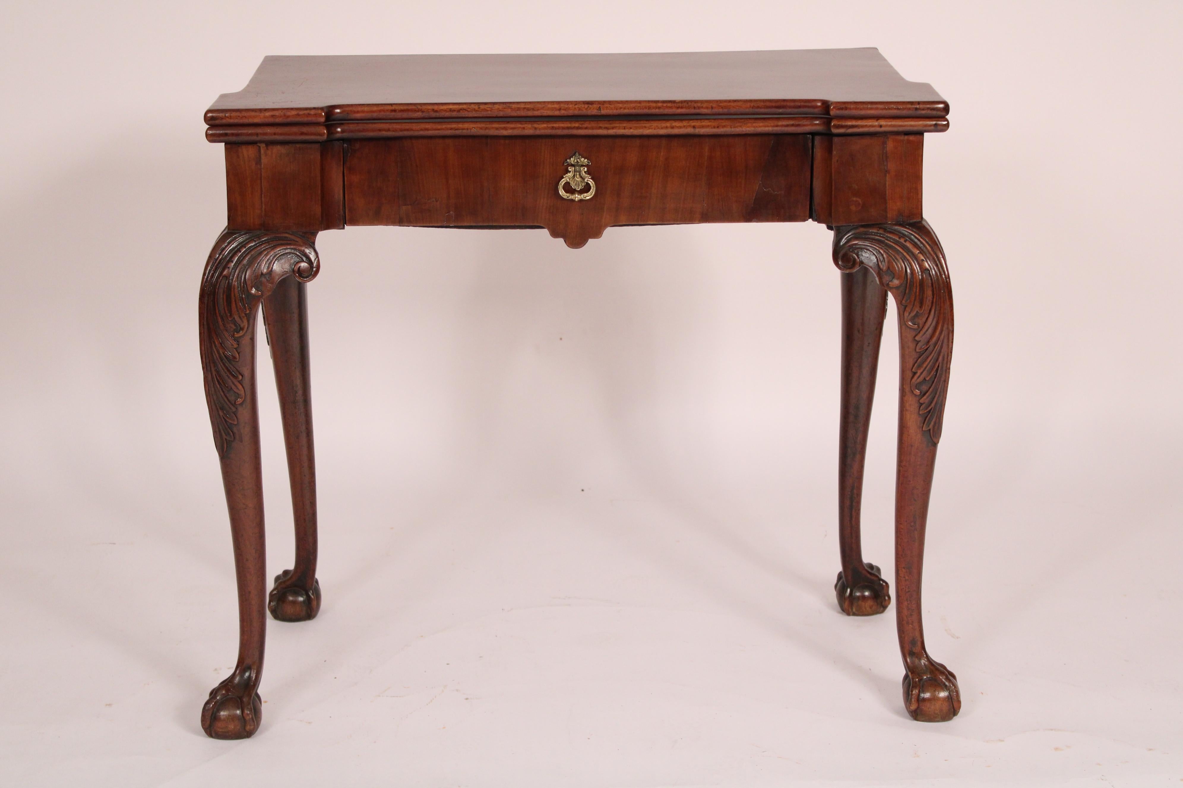 George II mahogany games table, 18th century. Having a rectangular top the front central area is recessed, a frieze drawer, resting on cabriole legs with acanthus carved knees terminating in ball and claw feet. Top when closed measures, width 31.5