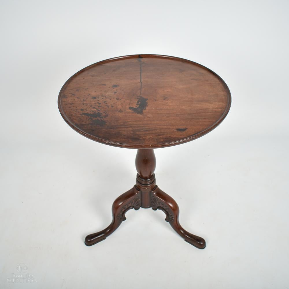 An extremely fine mahogany tilt top circular pedestal table circa 1770 on a turned column with three finely carved splayed legs onto a pad foot. Excellent colour and condition.