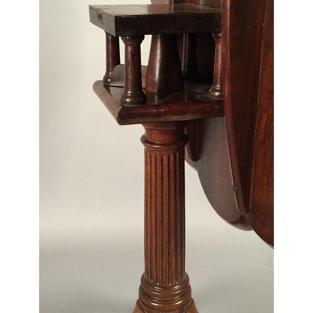 A George II-period mahogany scalloped-top tripod table.
Mid-18th century, circa 1740-1750.

The carved, lobed-edge, one-piece top is supported on a birdcage, tapering fluted column, and a tripod base terminating in pointed pad feet.
This fine