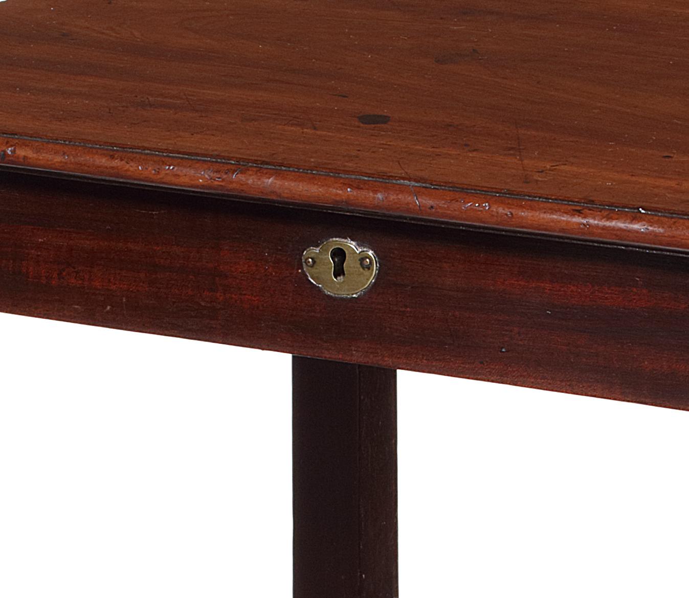 The table has a rectangular molded edge top above a frieze drawer, on square section legs joined by a concave undertier, on castors.

A closely related pair of tables labelled William Wilson and formerly with Apter Fredericks are illustrated in