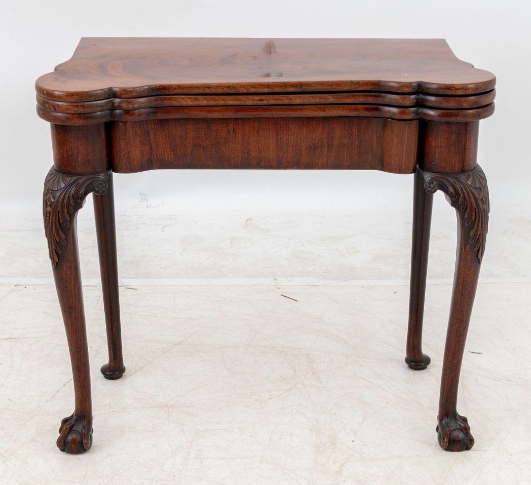 George II Flame Mahogany Triple Top Fold-Over Games Table, circa 1730, with single frieze drawer on acanthus leaf-capped cabriole legs above claw and ball feet. Closed state: 29