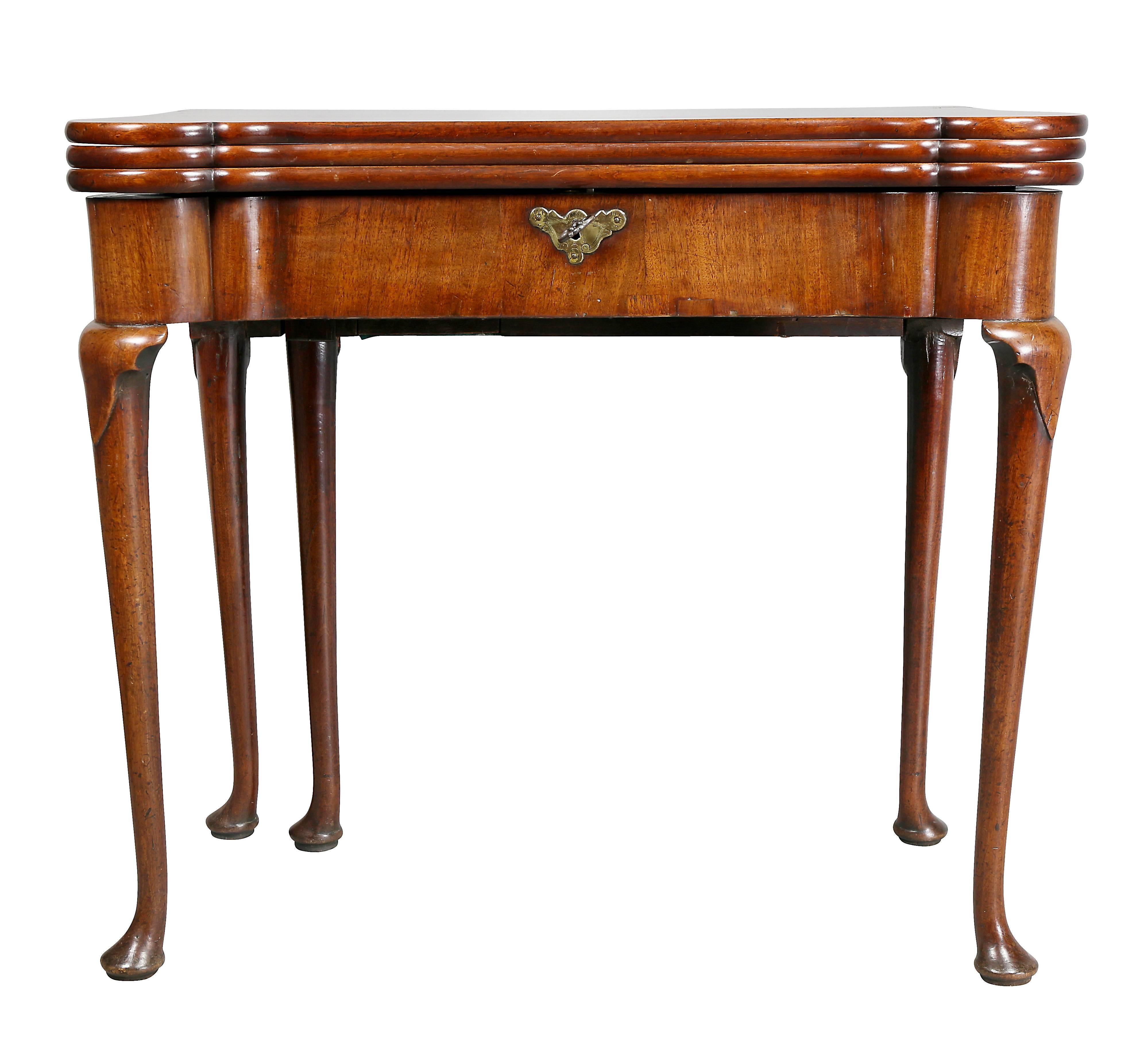 With triple hinged top with turret corners opening to a fitted card surface and backgammon, ratcheted reading stand and swing out inkstand, raised on slight cabriole legs and pad feet.