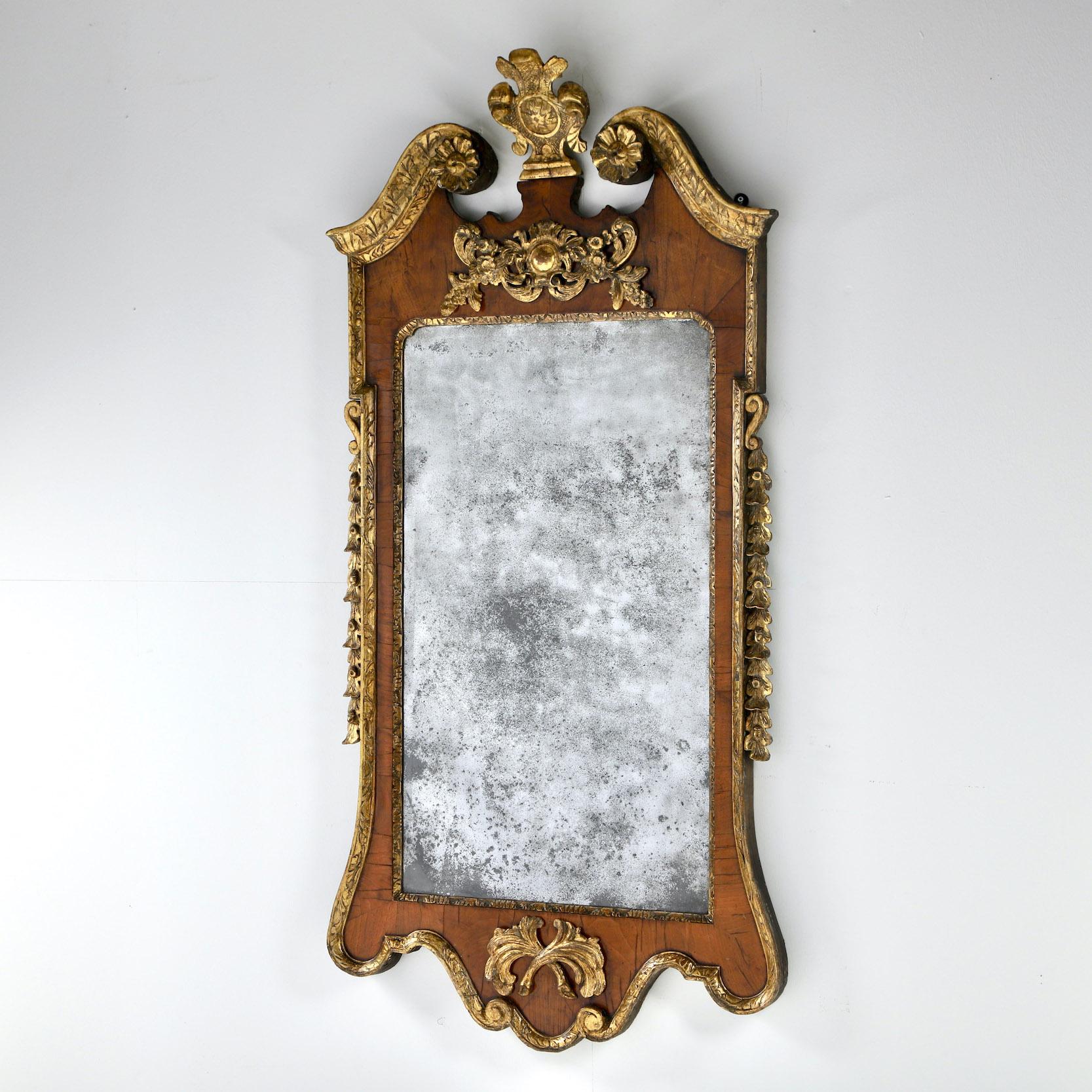V A G A B O N D presents a fine George II walnut and parcel gilt mirror in the manner of William Kent, with its original mirror glass.

England, Circa 1730

Provenance: Private collection, Kent House


