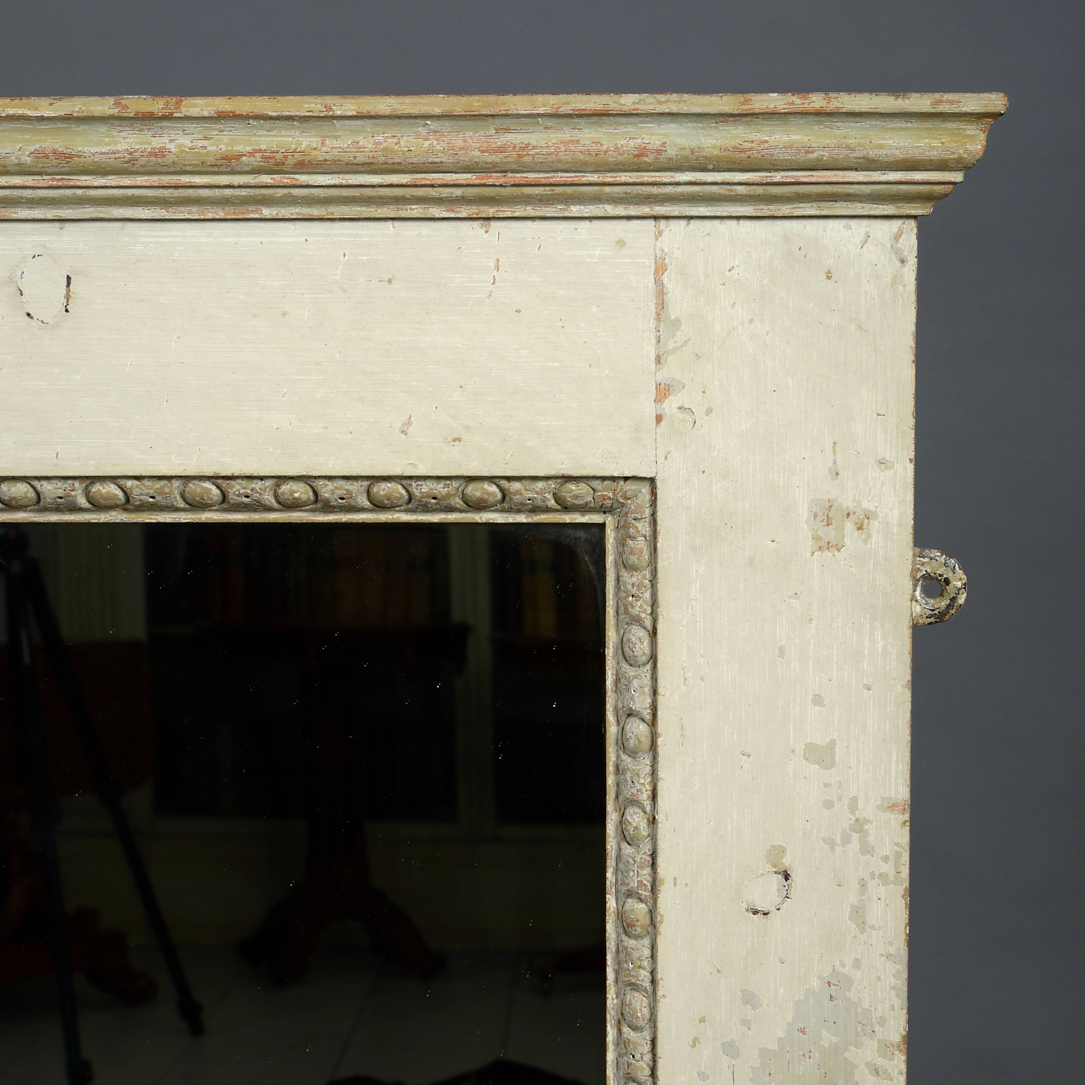 A George II stone-painted overmantel mirror, with egg and dart carved moulding, circa 1740.

Provenance
Wentworth Woodhouse, Yorkshire.