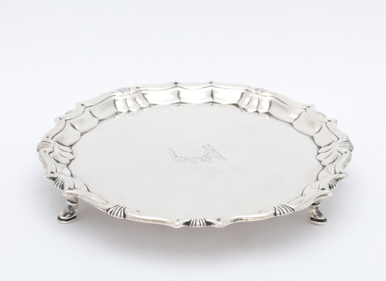 George II, sterling silver, footed salver/tray, London, year-hallmarked for 1744, Robert Abercromby - maker. Scalloped border. Salver has a central armorial of a raised arm in armor holding a scimitar. Measures almost 6 3/4 inches diameter x 1 inch
