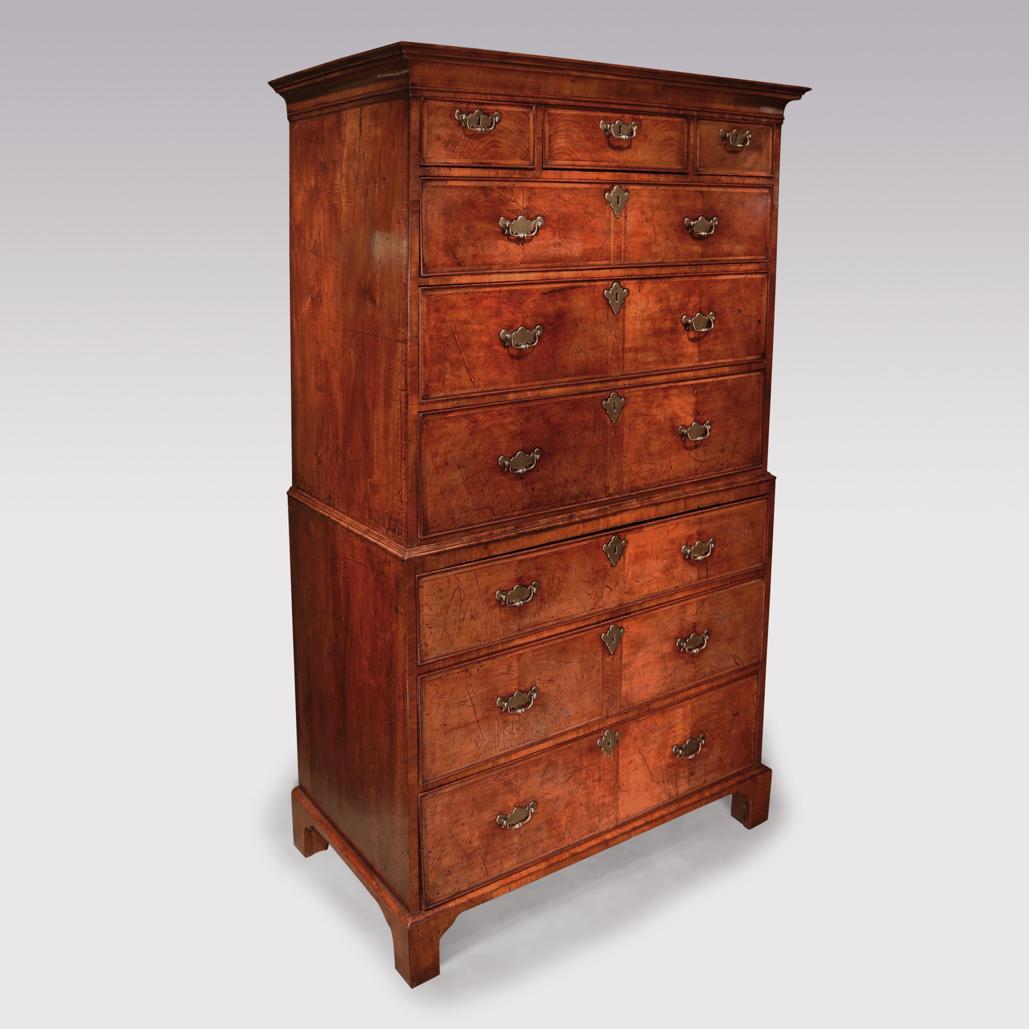 A George II period golden coloured walnut tallboy having moulded cornice above herring bone inlaid cockbeaded drawers retaining original handles. The long drawers veneered to resemble 2 short drawers. The piece, having end-grained mouldings and