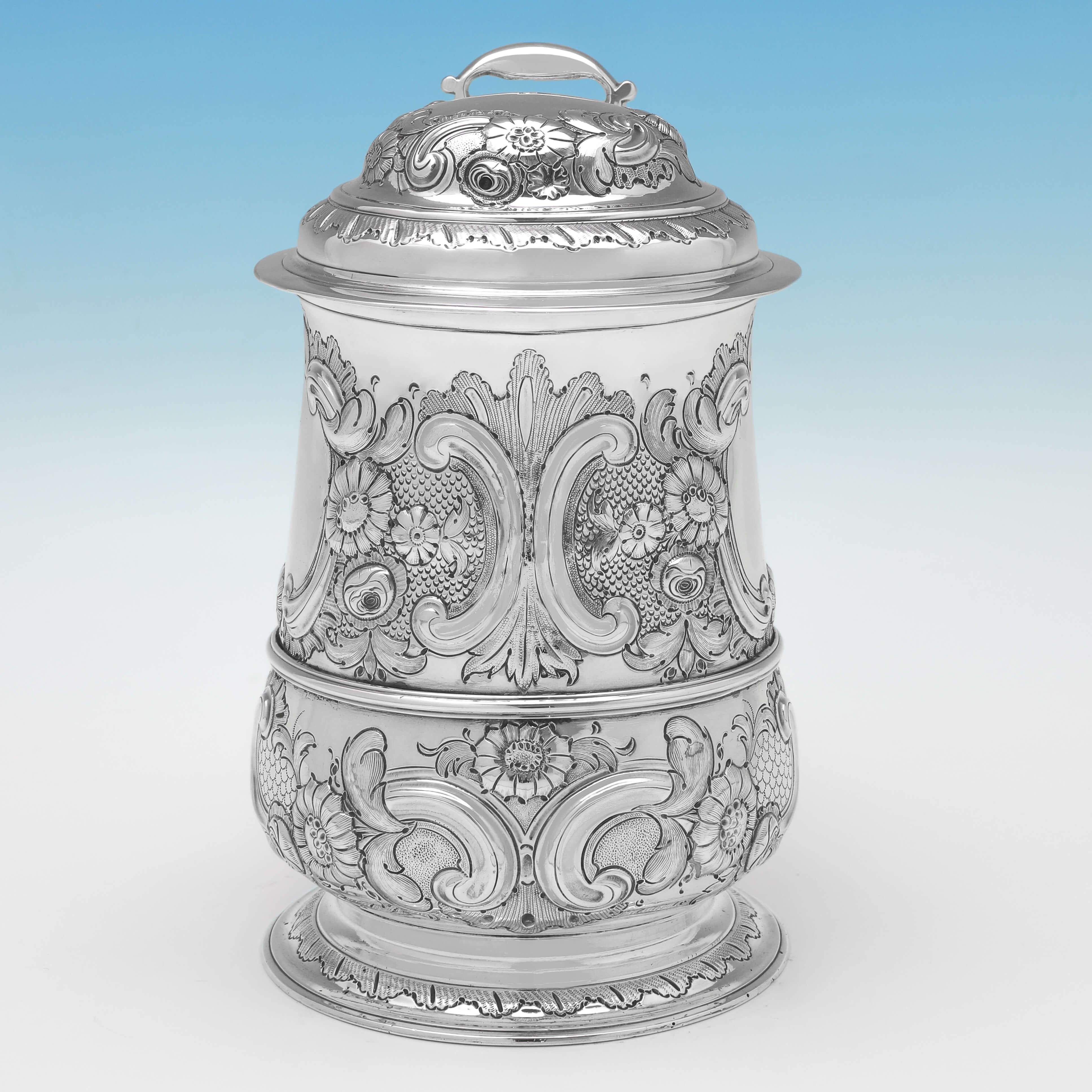 Hallmarked in Newcastle in 1756, this attractive, George II, Antique Sterling Silver Tankard, has been later chased during the victorian period to show the more ornate taste favoured at this time. 

The tankard measures 7