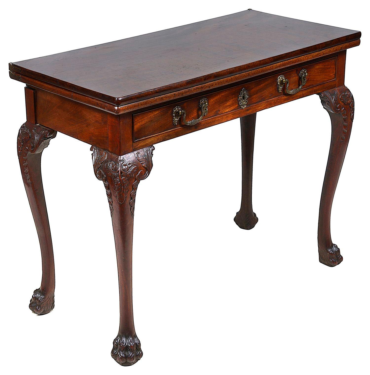 A very good quality 18th Century George II Mahogany folding card table, the top hinging open to reveal the baize covered card playing surface. A single frieze Oak lined drawer. Raised on beautifully hand carved cabriole legs with scrolling foliate