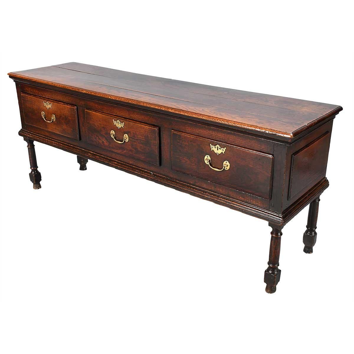 A three drawer dresser on turned legs, the back legs turned just as well as the front. Good quality molding to the top edge and below the drawers. Each drawer with a single handle. Exceptional color and patina. Brasses replaced.