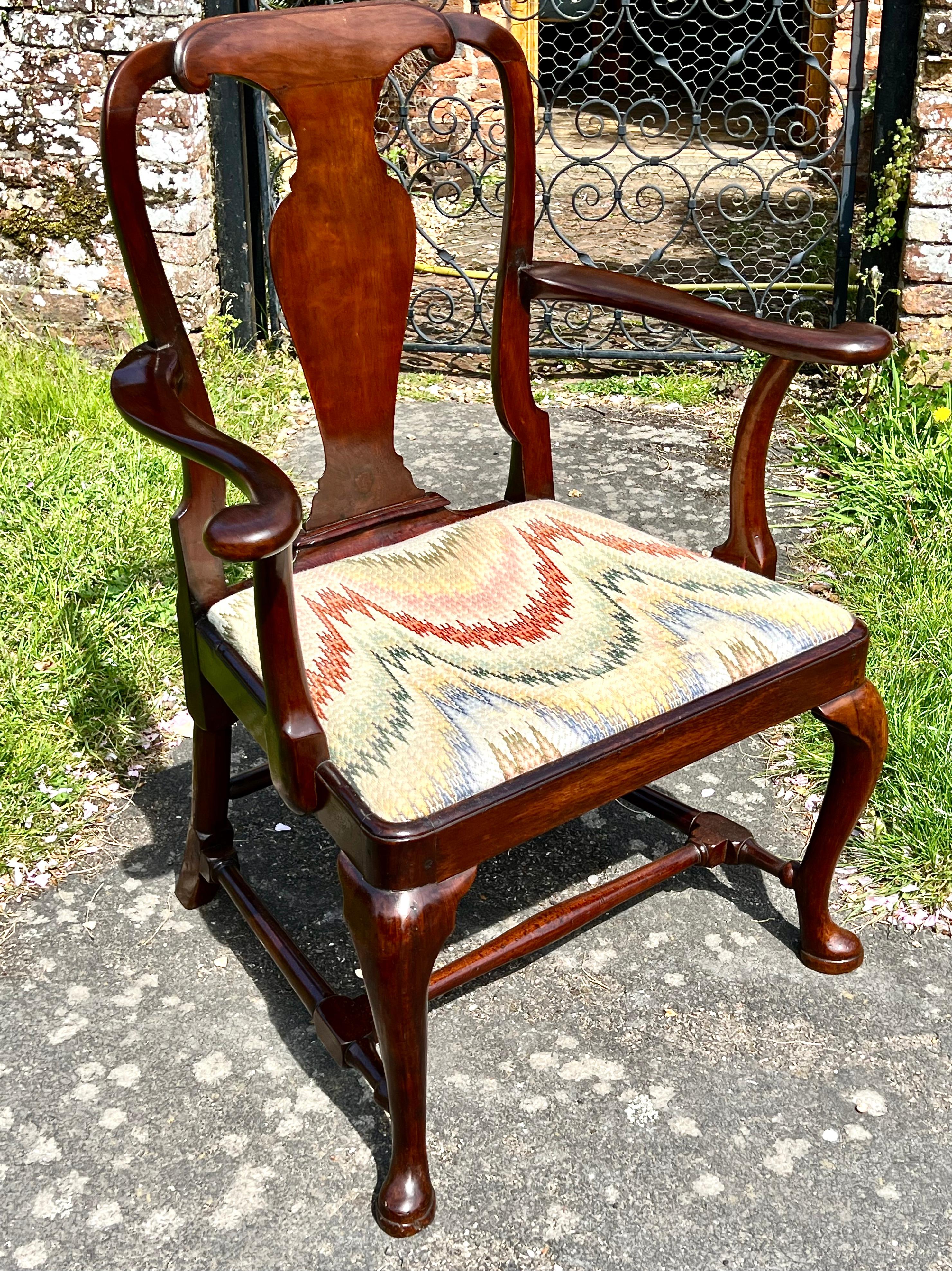 An elegant early 18th-century red walnut armchair, circa 1730.

This smart and useful desk chair (or 'occasional' chair) has a slip-in seat covered in point d'Hongerie.

Of deep patinated colour with some evidence of historic restoration, although
