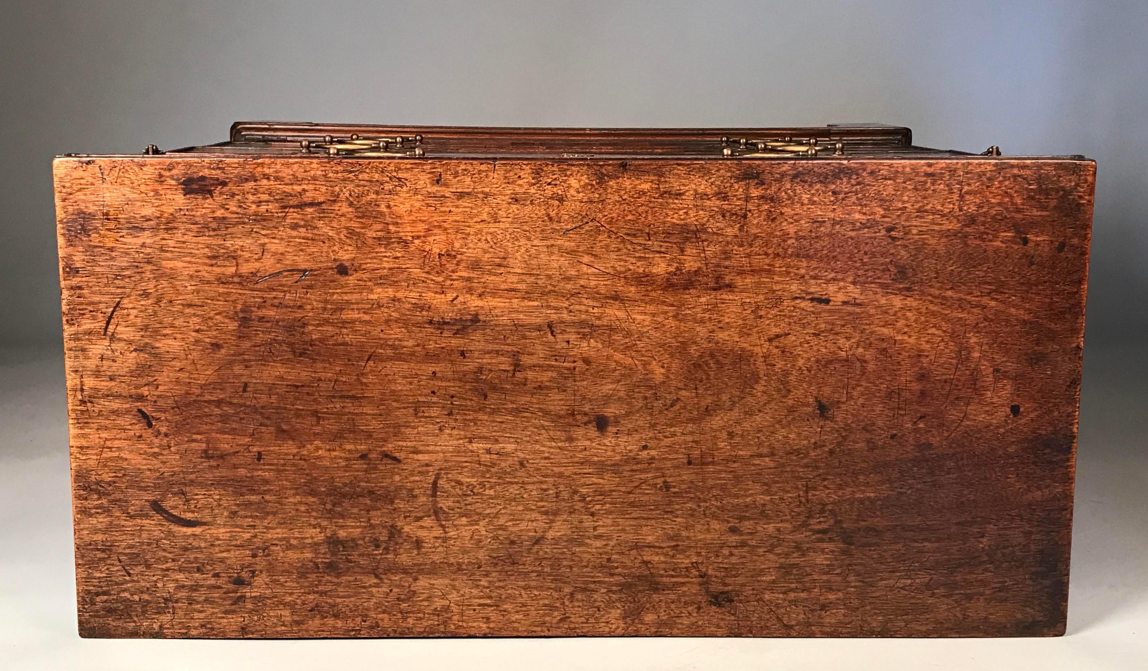 Antique English red walnut fold-over top bachelor's chest. George II period, circa 1750.
This small size Georgian (mid-18th century) bachelor's chest is in solid walnut. 
Very good color and old patination.

The hinged fold-over top has the unusual