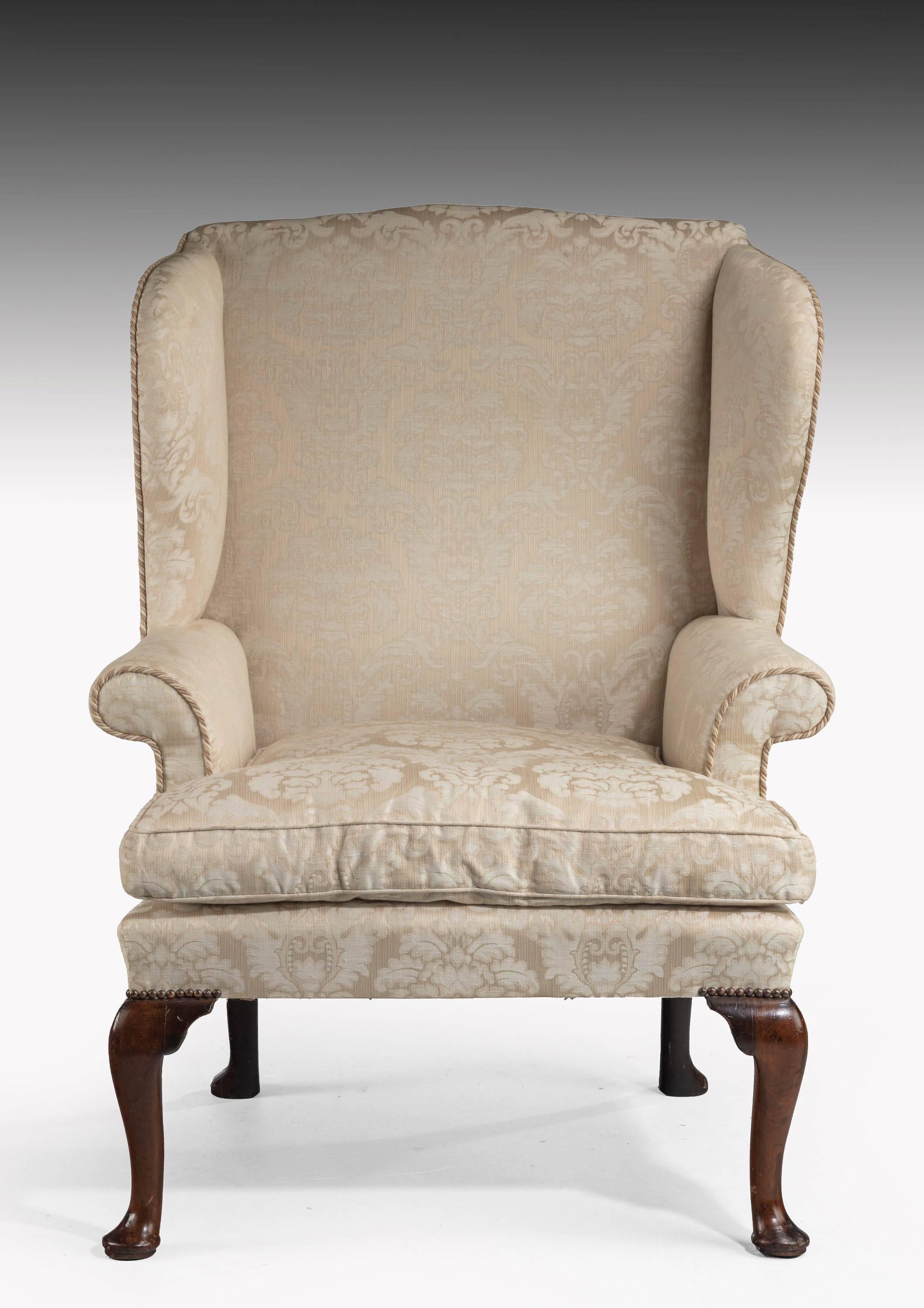 A George II period wing chair with walnut cabriole legs. The whole of a generous size.

Seat height 17 inches.