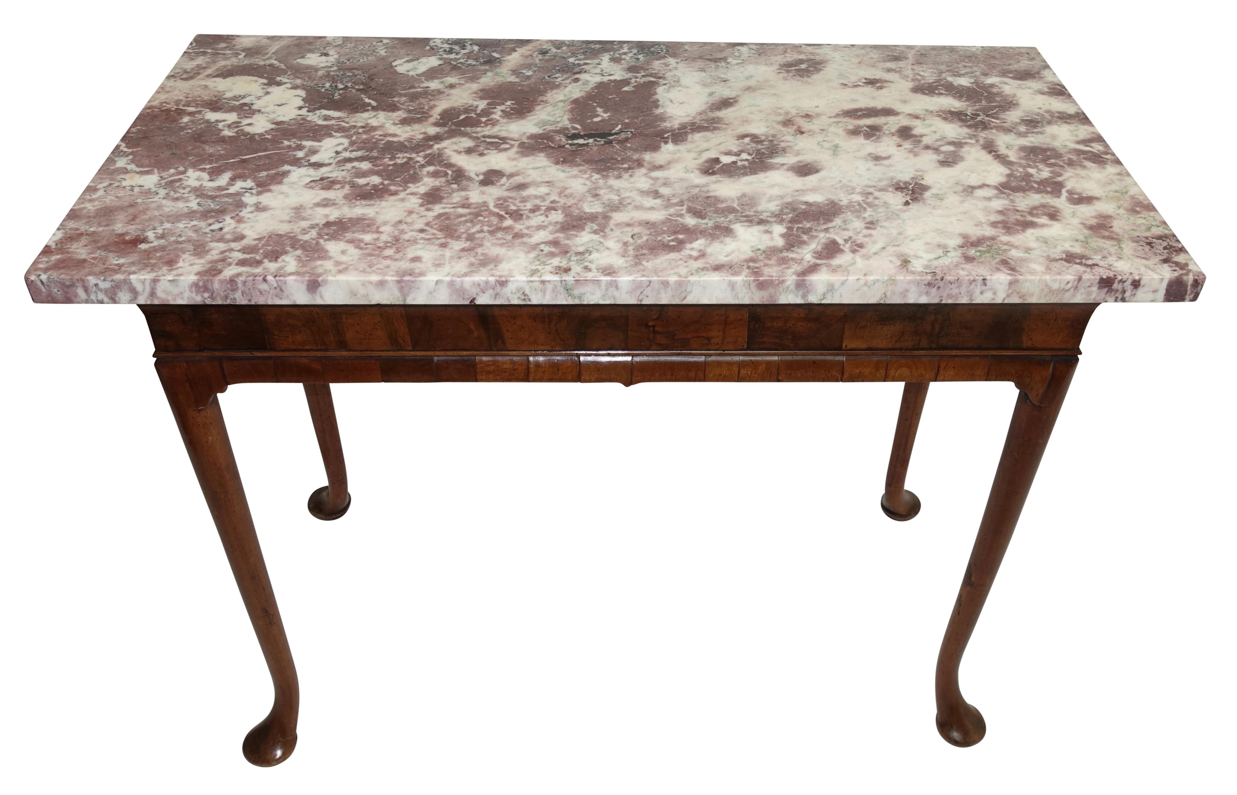 Wonderful George II period walnut pier or console table, circa 1740, with associated marble top. Beautiful and well proportioned Brescia Violeta marble top is supported by a walnut base with a cavetto modeled frieze veneered in burl walnut,