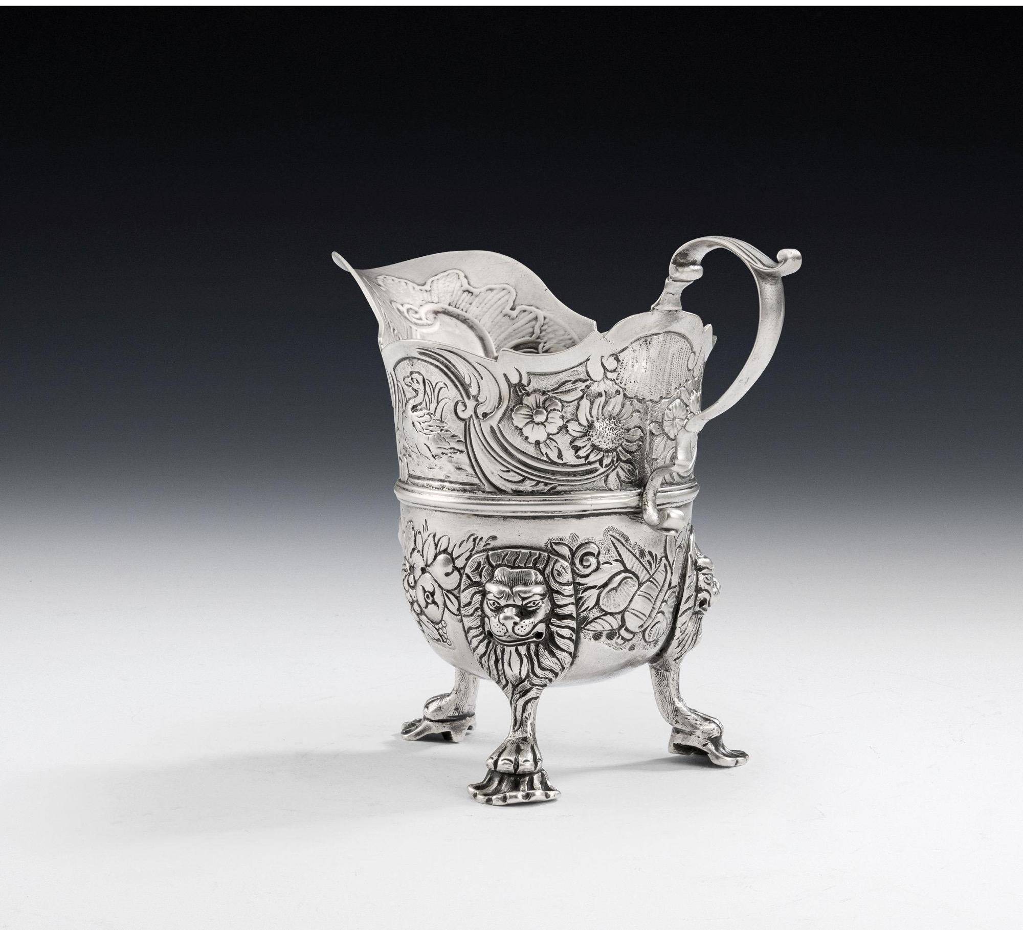 A Rare & Exceptional George II Rococo Irish Milk Jug Made in Dublin circa 1750 by Samuel Welder.

The Jug is of typical Irish design and stands on three unusual paw and shell feet which are attached to the main body with unusual smiling lion mask