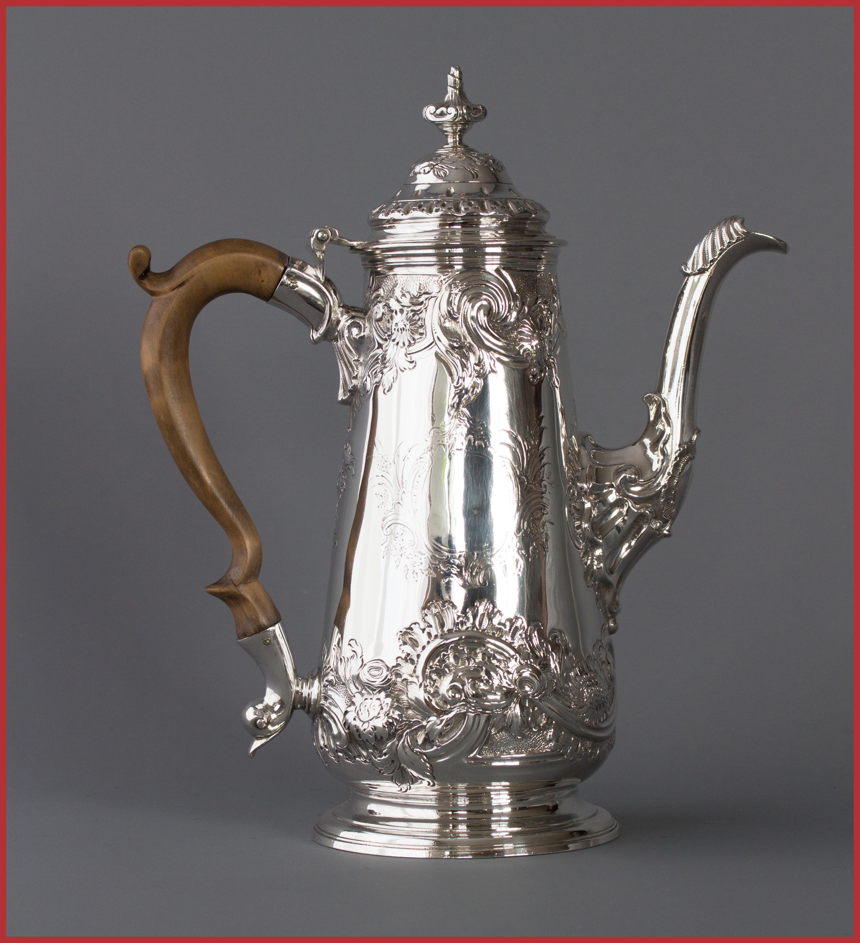 An excellent quality George II silver coffee pot by the renowned Huguenot silversmith Samuel Courtauld. Of plain tapering baluster form with embossed floral and scroll decoration, cast leaf-capped spout, a high raised floral decorated domed lid with