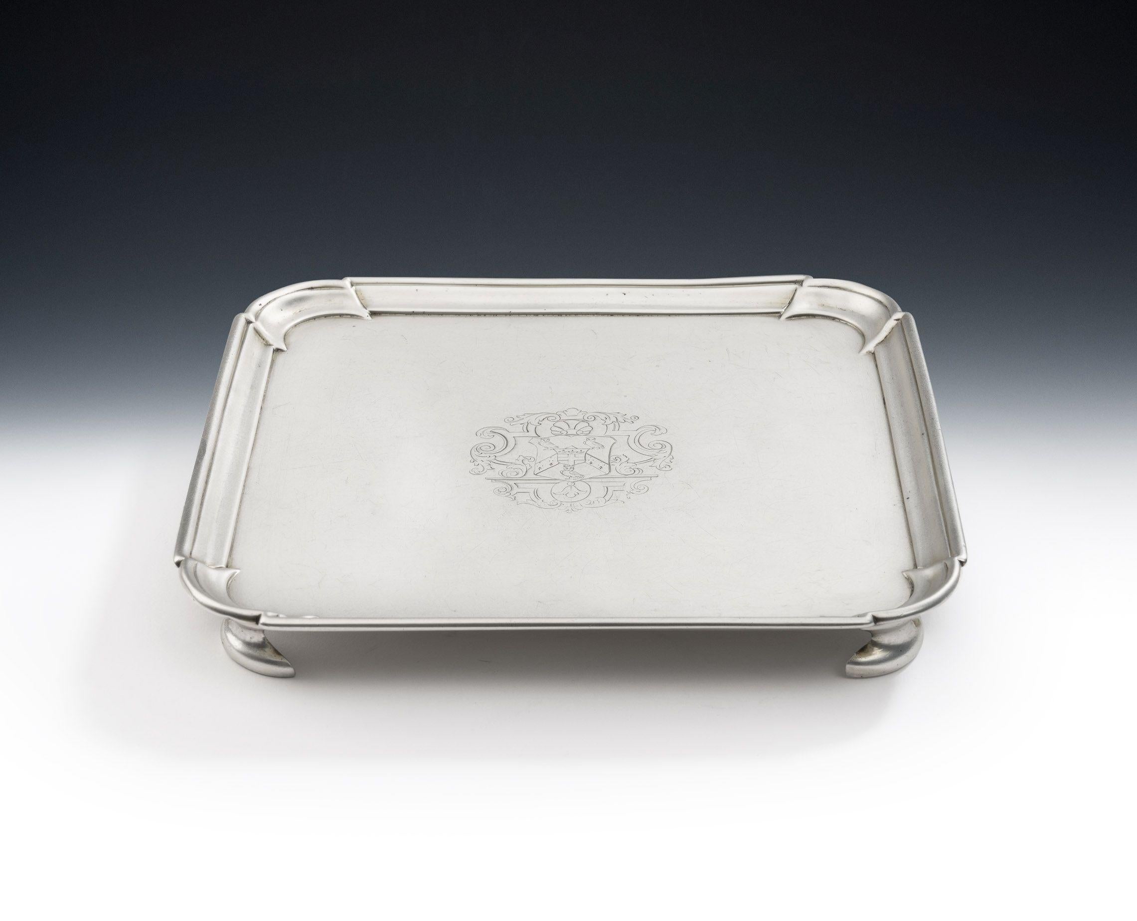 A very fine George II Square Salver made in London in 1729 by Matthew Cooper I

The Salver stands on four unusual shaped cast feet and the raised, stepped, rim displays incuse corners.  The centre is engraved with a contemporary Armorial surrounded