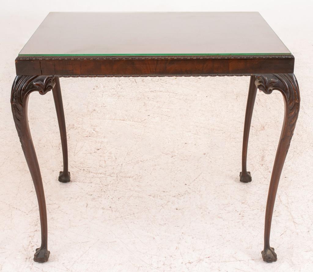 George II style mahogany side tea table with carved apron raised cabriole tapered legs ending in claw and ball feet, glass top.

Dimensions: 27.5