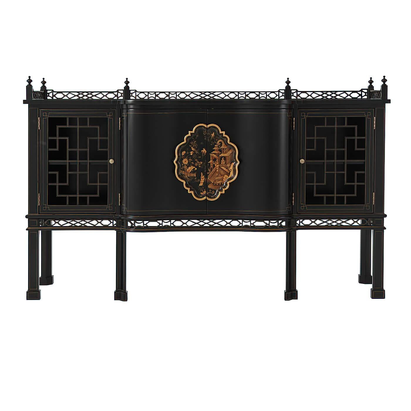 A fine George II style Chinese Chippendale ebonized serpentine sideboard, the breakfront top with a pierced fretwork gallery above two fretwork trellis doors enclosing two further shaped doors with an elaborate Chinoiserie painted cartouche handle,