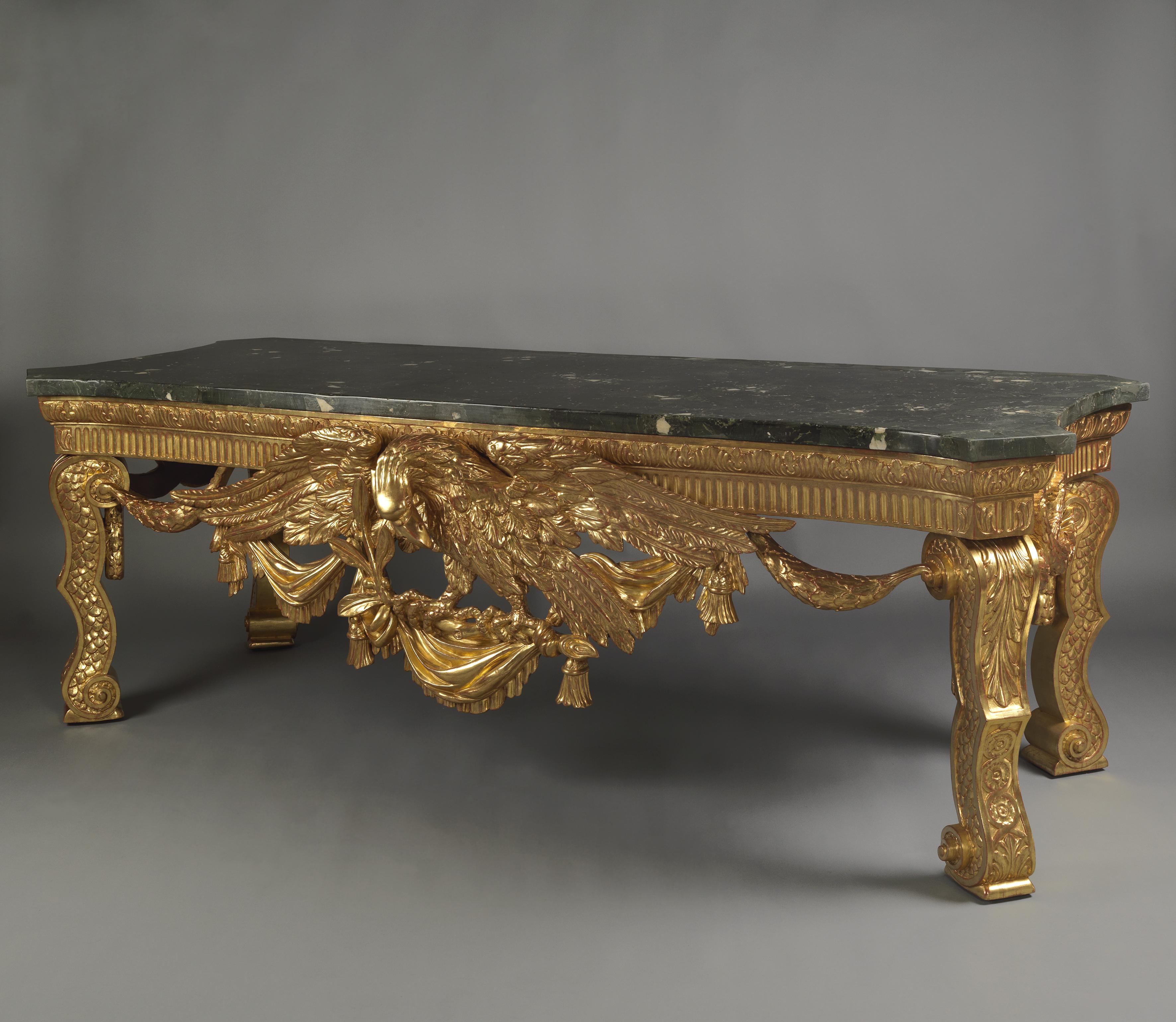 An impressive George II style giltwood console table in the manner of William Kent.

English, circa 1900, incorporating some 18th century carved elements. 

This large and impressive carved giltwood side table has a shaped rectangular Verde