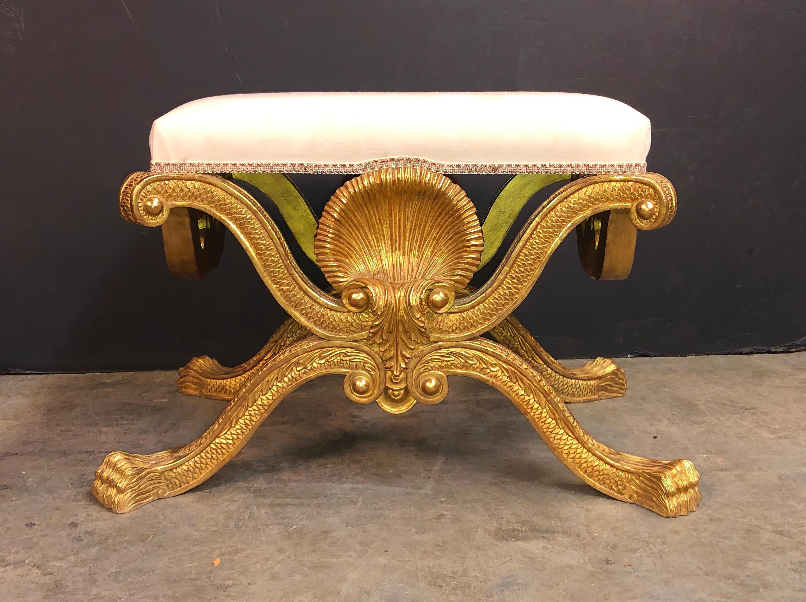 George II style carved giltwood stool in the manner of William Kent, with a boldly carved shell, scrolling supports with carved fish scales and on lion paw feet.
