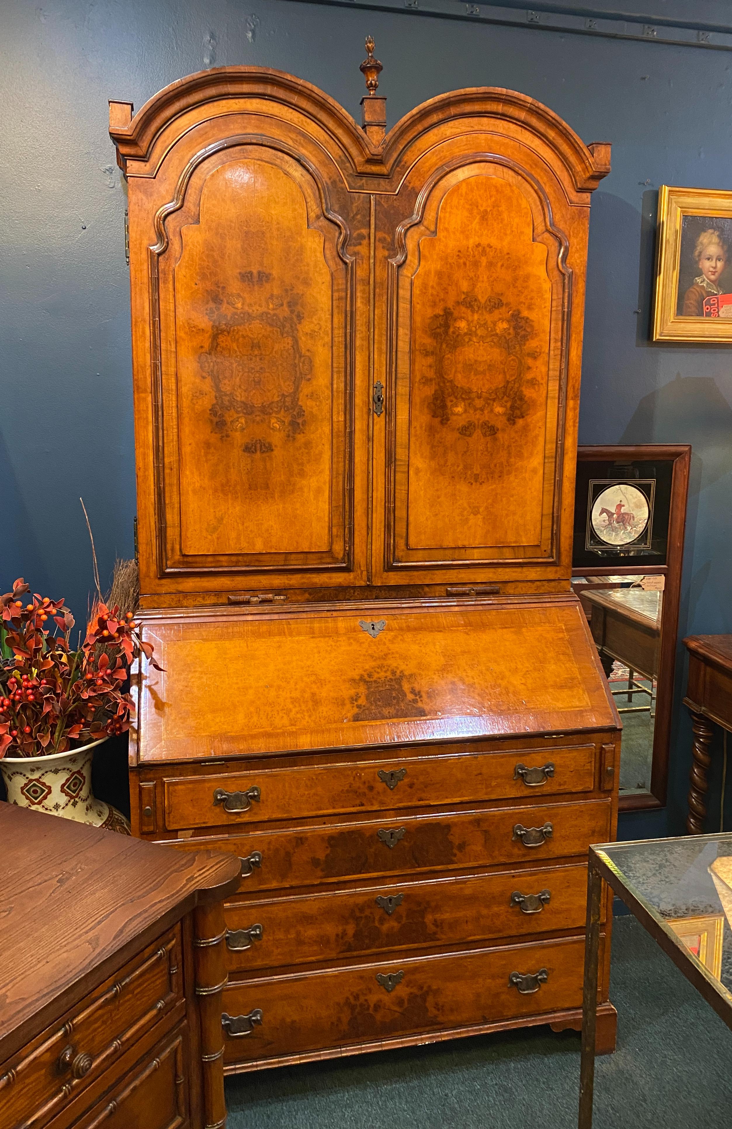 George II style Inlaid Burl walnut slant front bureau bookcase. Molded double dome cornice above a case fitted with doors over a slant front and a case fitted with four drawers on bracket feet
Measures: 84.5
