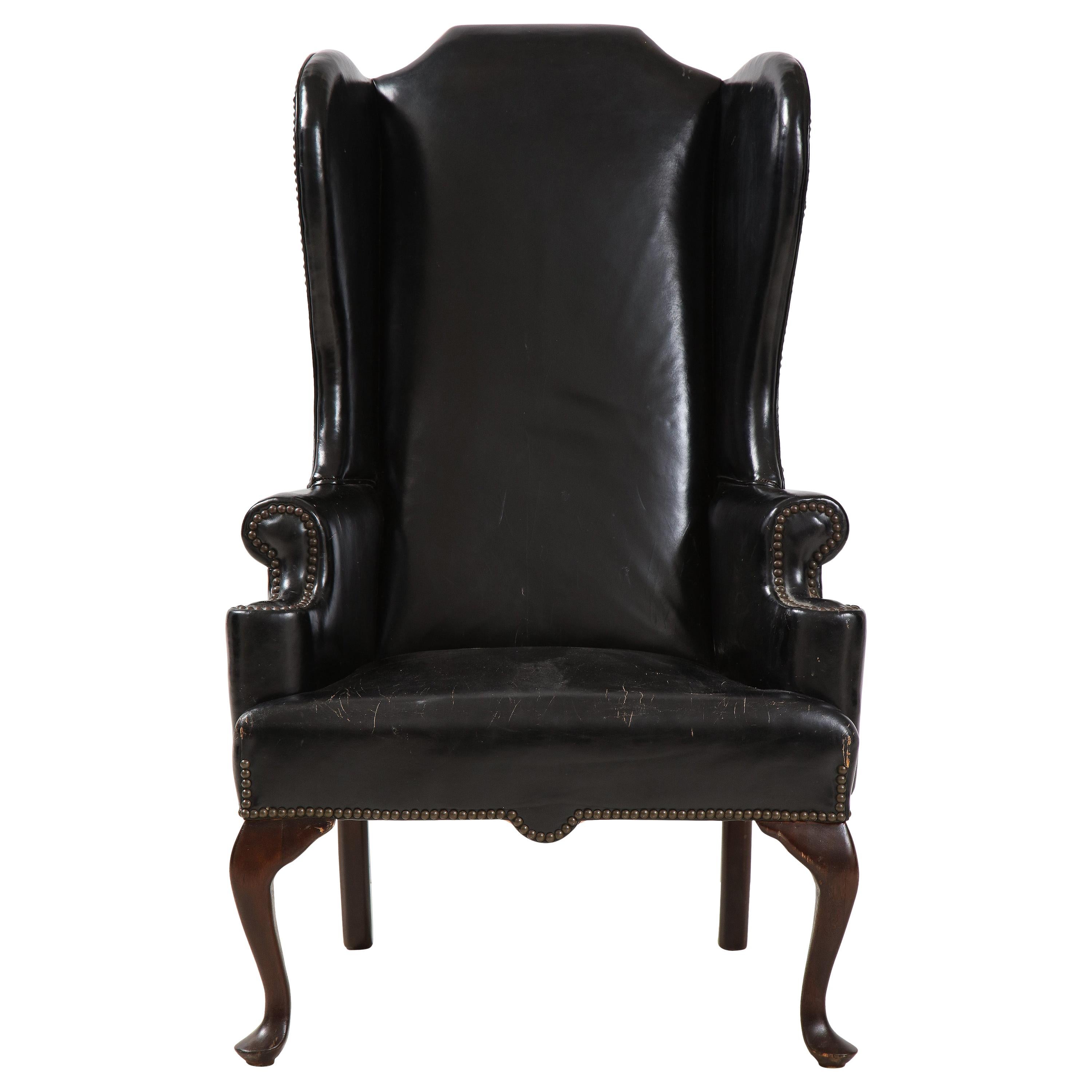 George II Style Mahogany and Black Leather Upholstered Wing Chair