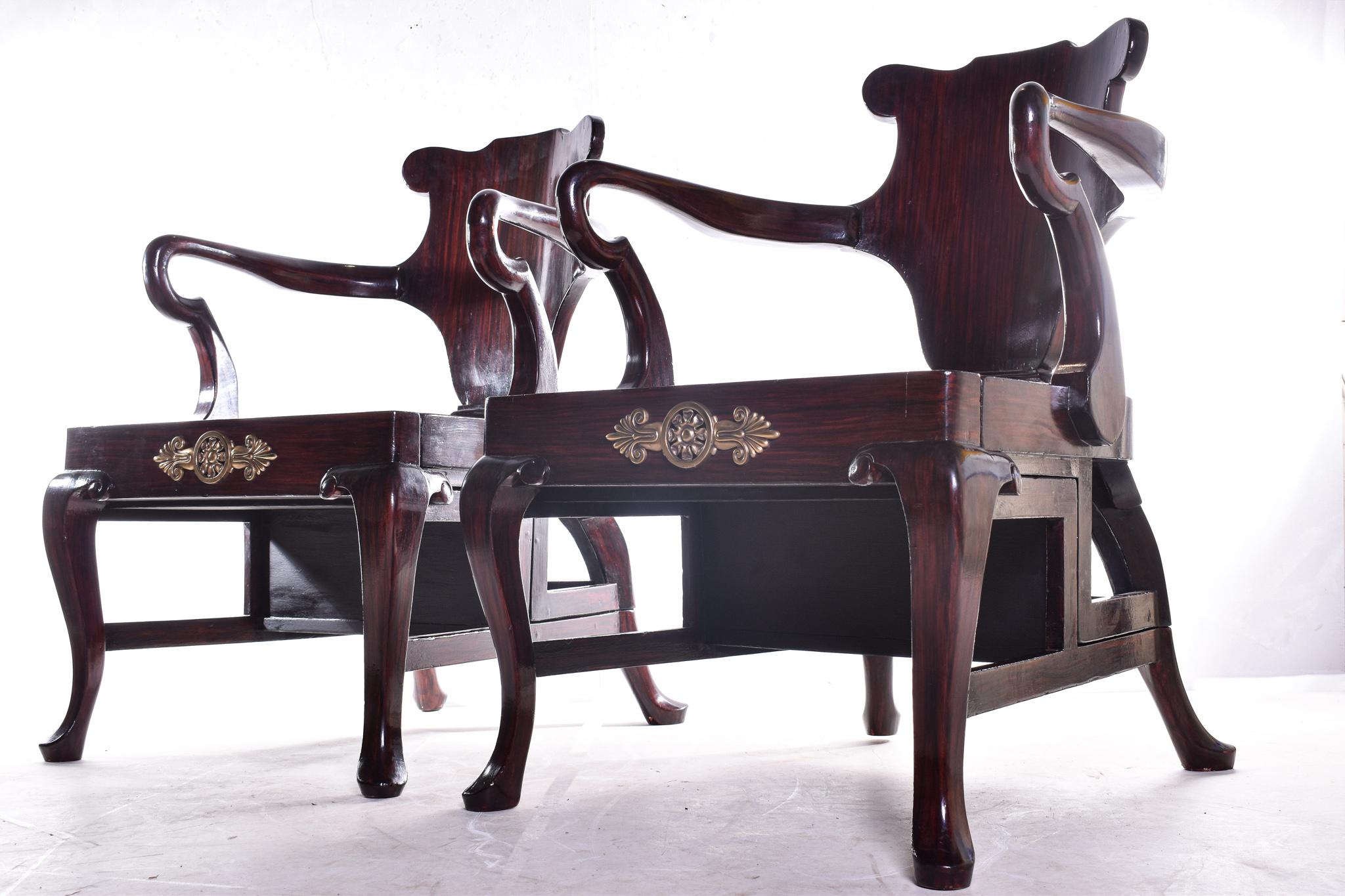 A highly elegant and unusual pair of simulated rosewood metamorphic armchairs, in George II style transforming into library steps with shaped solid backs above hinged seats resting on cabriole legs, with inset leather treads and Etruscan design