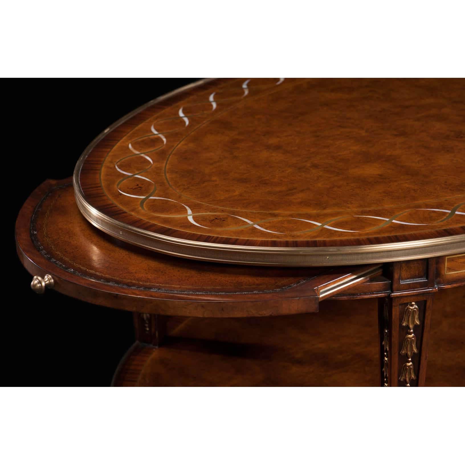A George II Style oval coffee table with pollard oak burl and Morado banding, mother of pearl and brass inlay to the oval top, end slides, shelf stretcher, on square tapering legs.
Dimensions: 48.25