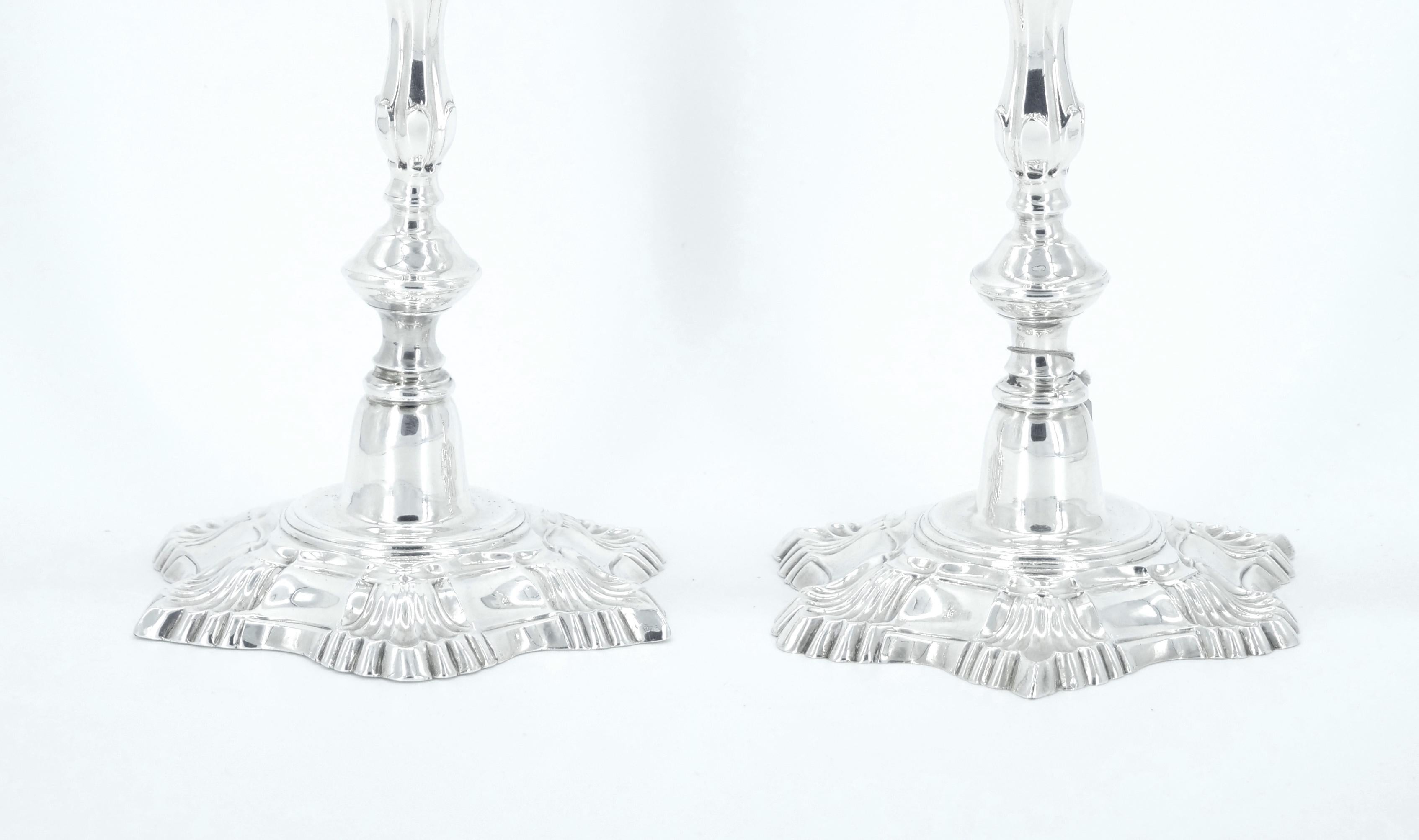 Elevate your table setting with this exquisite pair of antique silver-plated candlesticks, crafted in the late 19th century and showcasing the timeless elegance of the English Georgian style. Manufactured by Regent Sheffield, each candlestick is