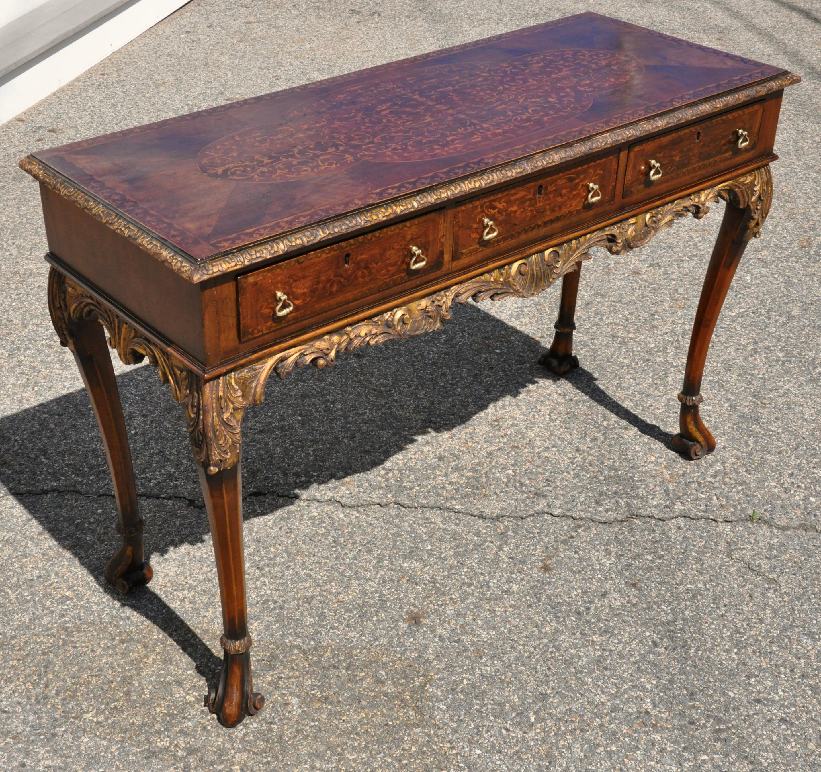 George II Marquetry inlaid side or sofa table. Figured walnut veneers with seaweed marquetry inlay. Cabriole legs with parcel gilt and carved aprons.

Three drawers in frieze. 17th Century style

Provenance: Prides Crossing Estate.