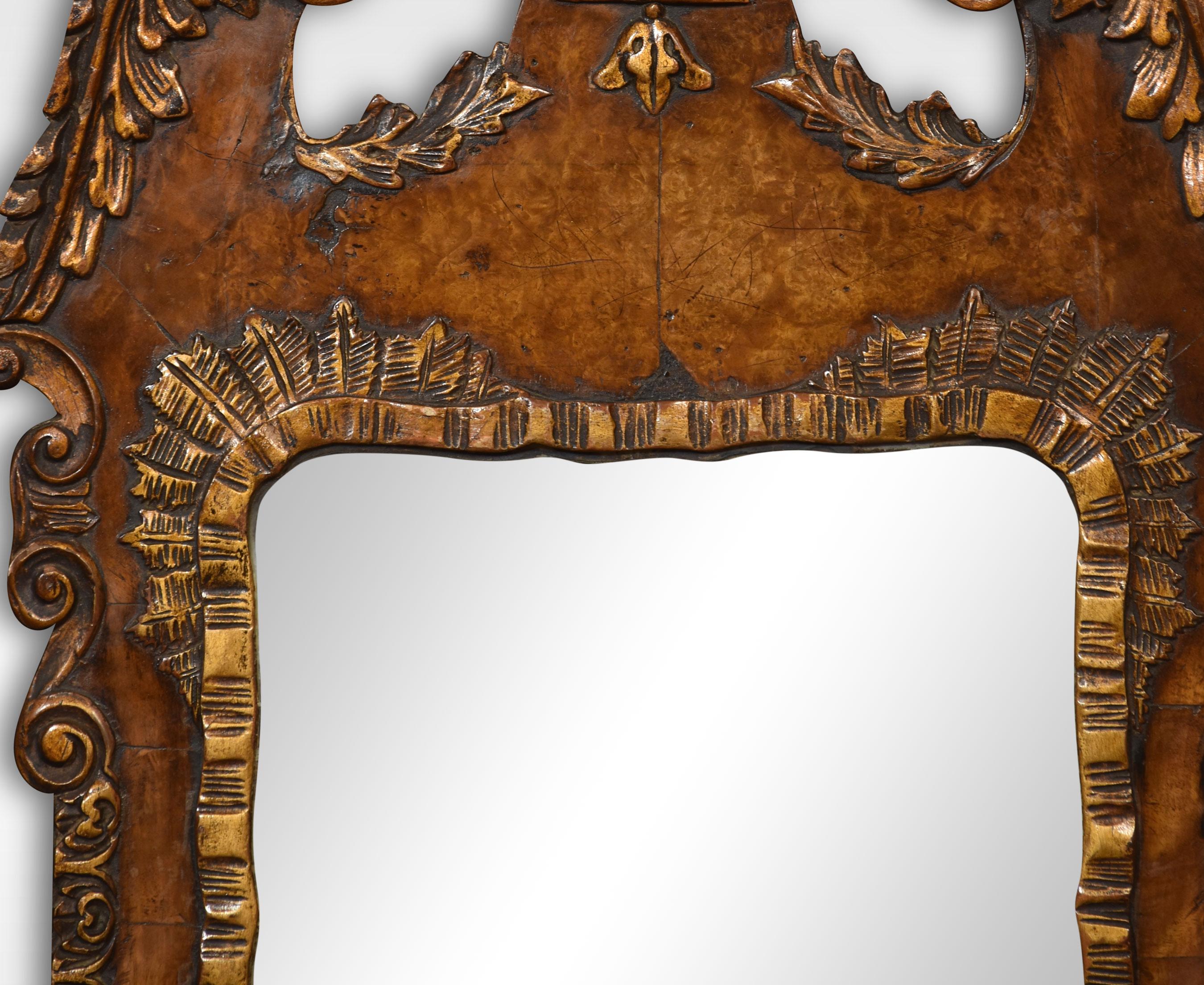 Walnut and parcel gilt wall mirror. The original rectangular mirror plate is surrounded by a walnut frame with carvings and applied scrolling decoration.
Dimensions
Height 40.5 Inches
Width 21.5 Inches
Depth 3 Inches