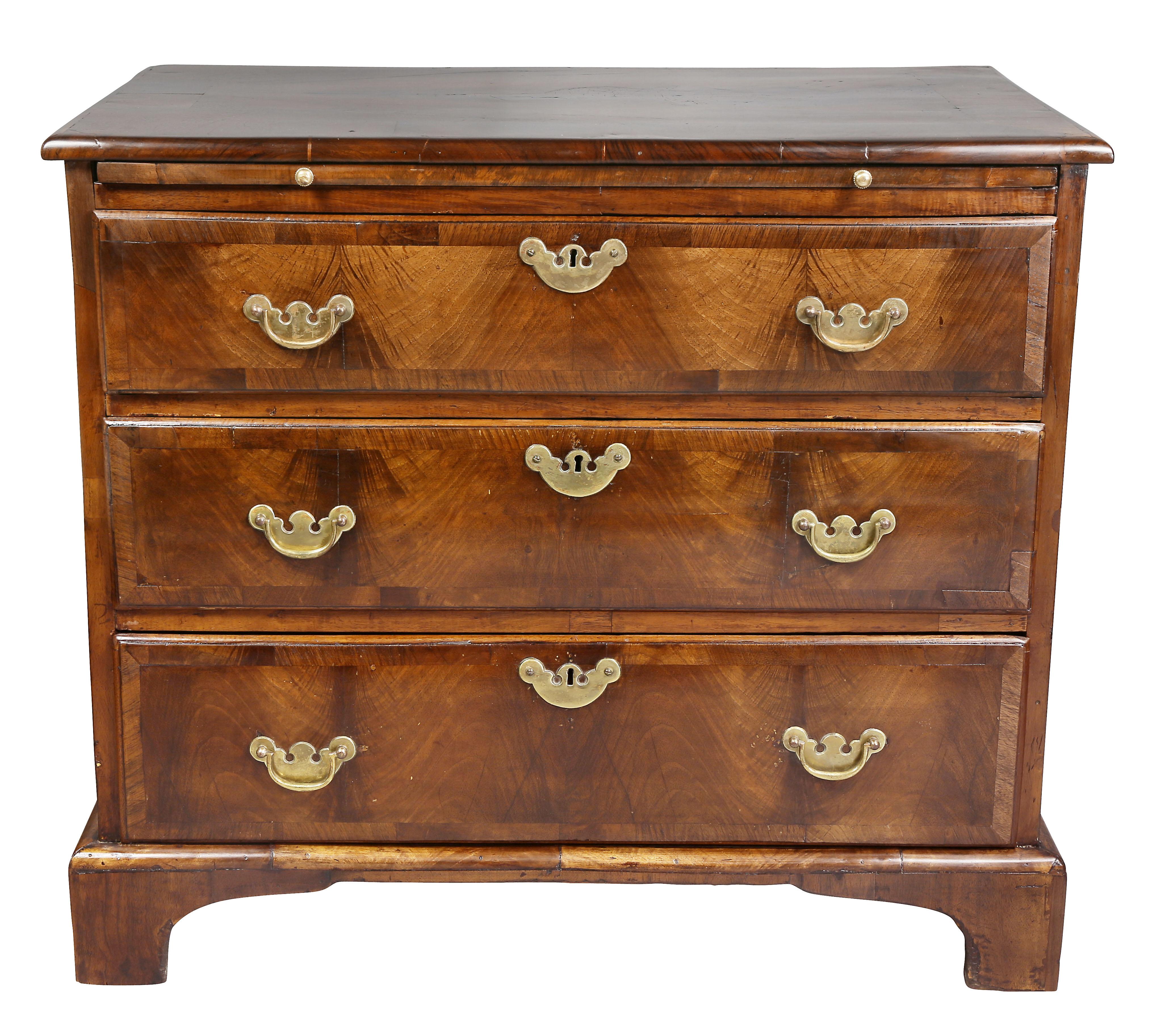 With rectangular top with molded edge over a brushing slide and three drawers, raised on bracket feet.