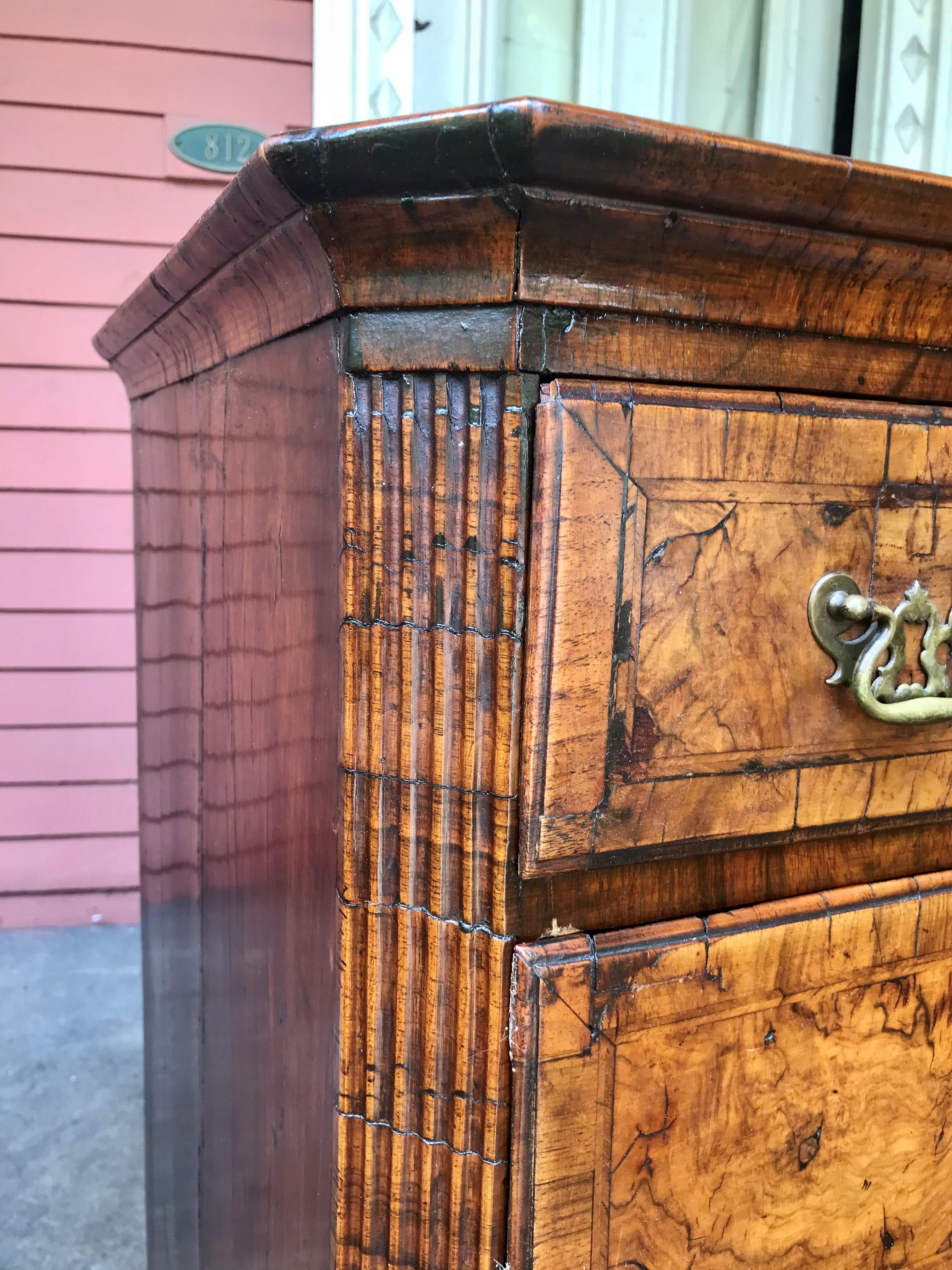 Sturdy Georgian chest. Stunning veneers and light color. The sides are solid boards.The top well worn and used ( note photo).Feet are later ,as is the hardware. Warm patina and color. The canted corners fluted or ribbed. with key.  Shows well .

The