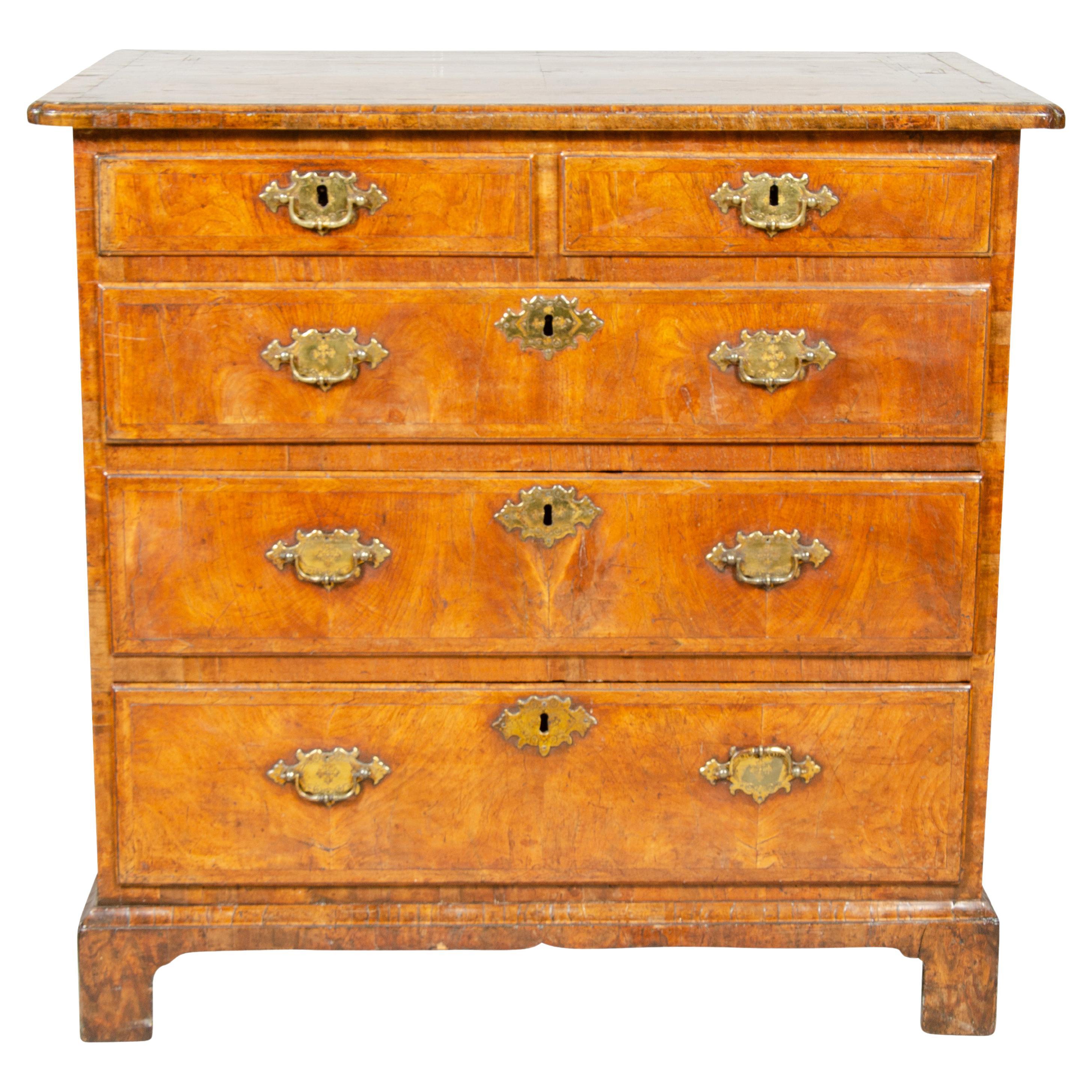 Great color and patina with rectangular top with book matched quarter veneers over two over three drawers, original handles raised on bracket feet. Nice small scale piece.