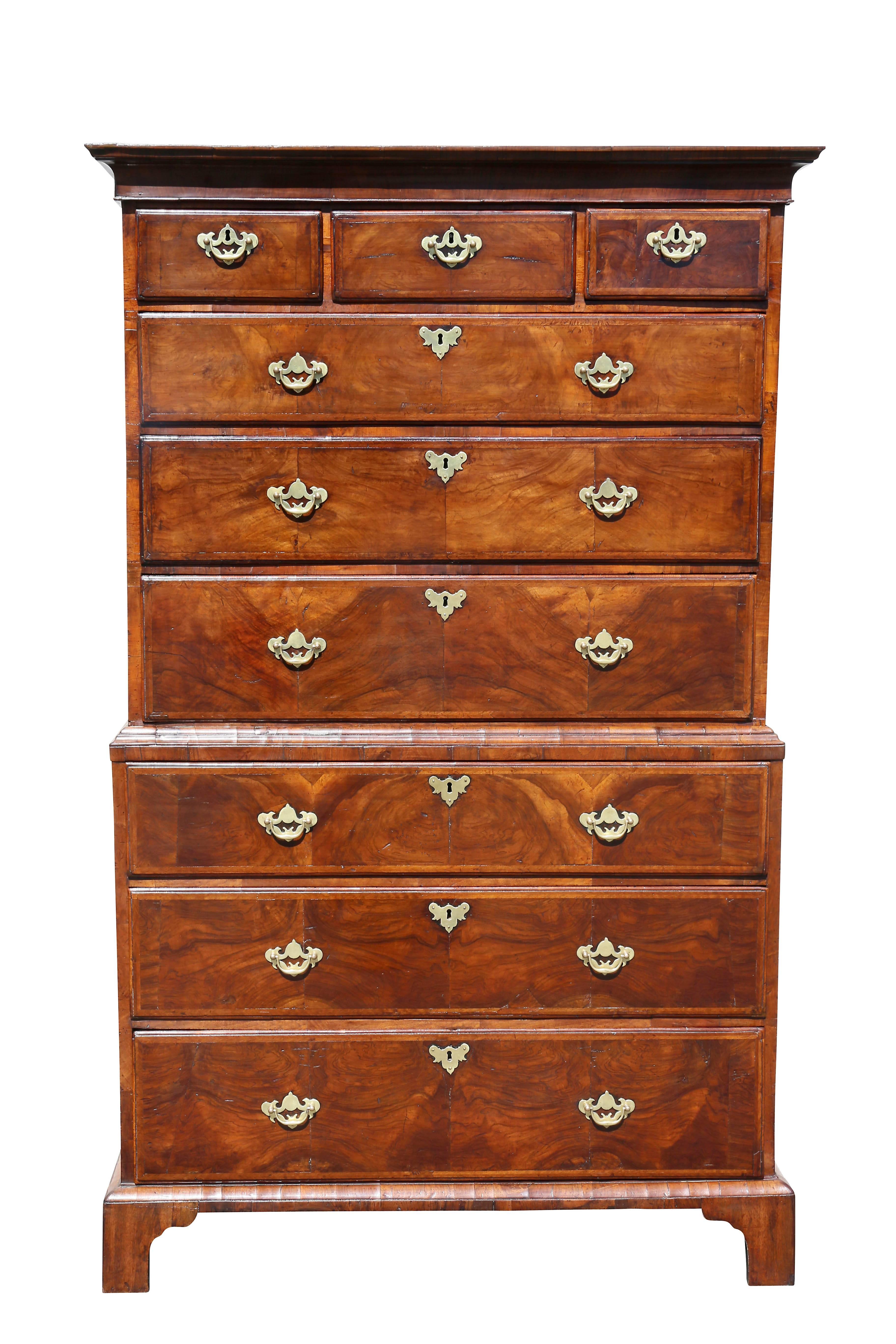 With molded rectangular cornice over three short drawers over three graduated drawers, the base with three graduated drawers, raised on bracket feet. Original handles. Overall original condition.