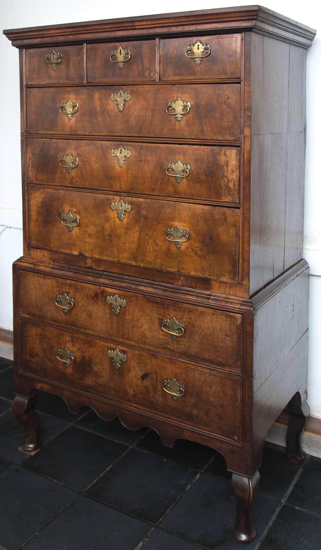 Stately George II walnut burr chest on stand with scalloped apron situated on cabriole legs. Fine example of 18th century craftsmanship. Oak lined drawers and original brass.