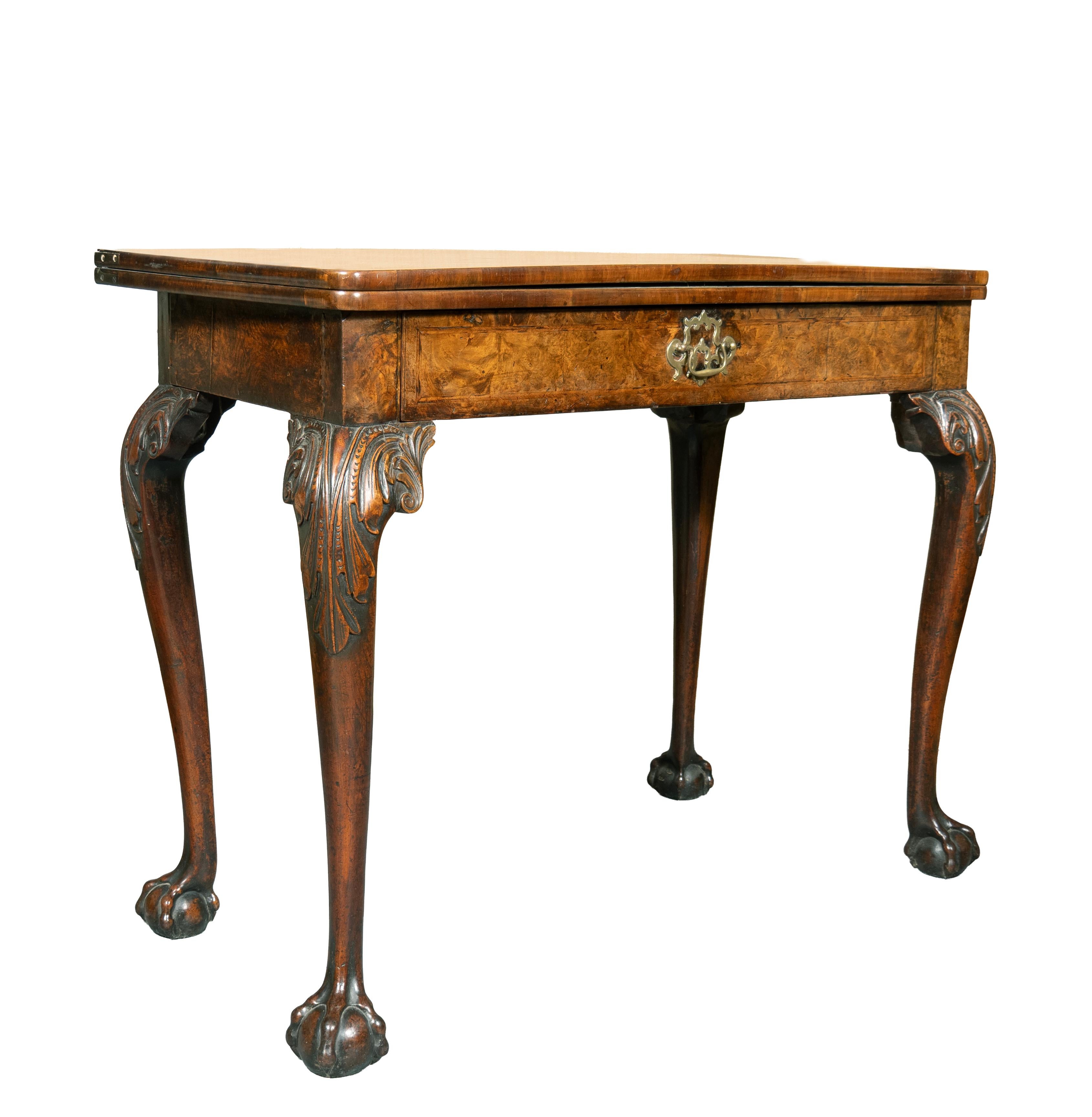 Rectangular hinged top opening to an as velvet lined surface over a frieze drawer with original bail handle. Raised on cabriole legs with acanthus carved knees and ending on ball and claw feet.