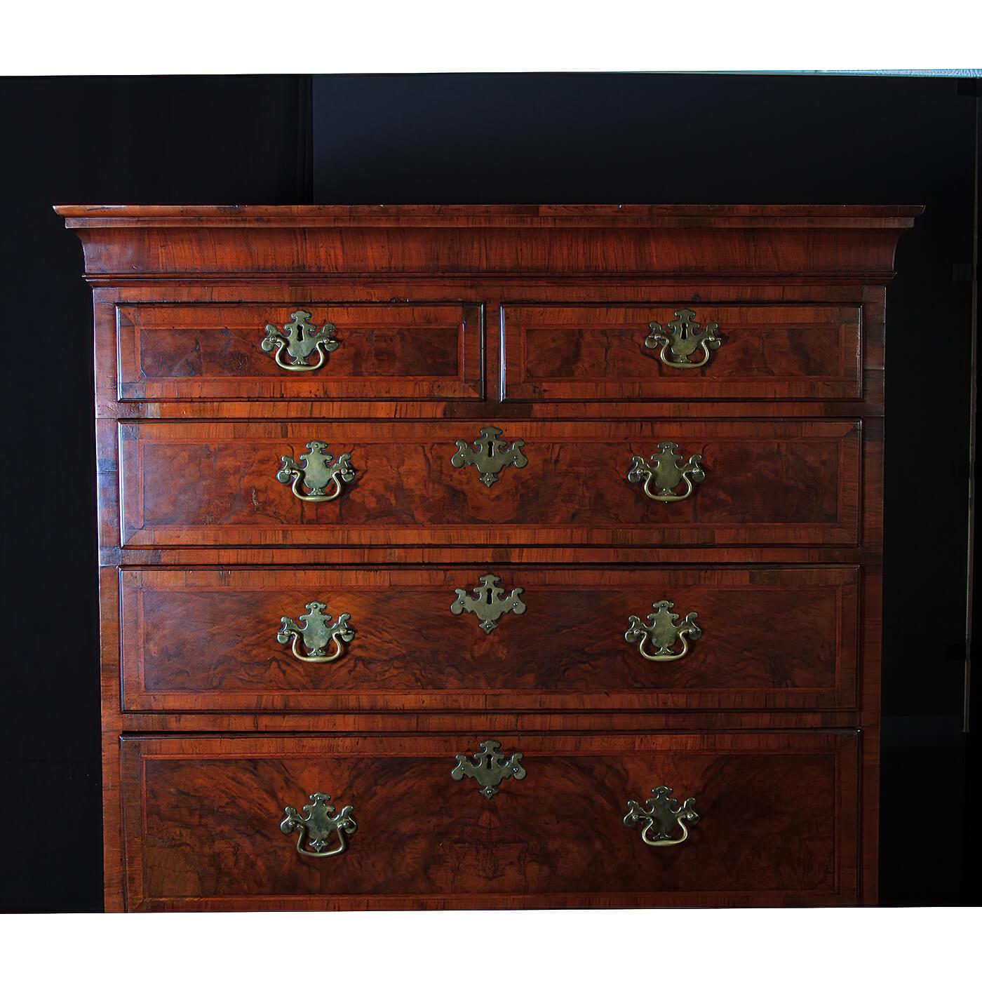 An early George II burl walnut and herringbone inlaid eight-drawer chest on chest. With wonderful burl panels surrounded with crossbanding, with a molded cornice, with brass winged handles, and raised on bold bracket feet. English, Circa