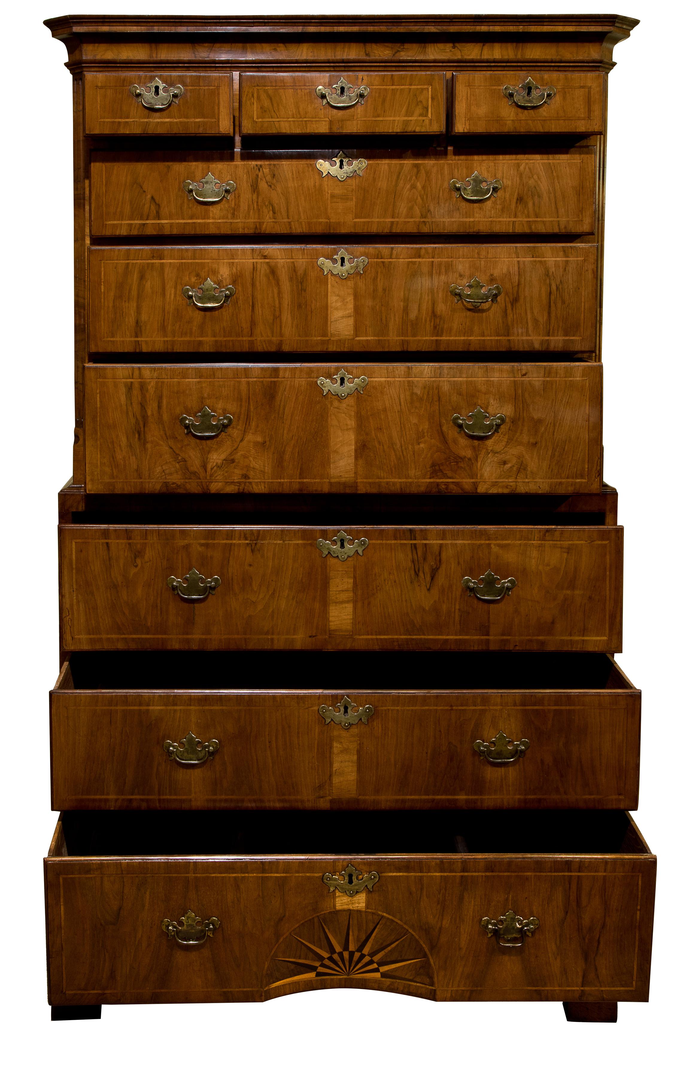 A fine and rare George II walnut secretaire chest on chest with fluted canted corners. The drawer fronts inlaid with a narrow walnut band, the bottom drawer further inlaid with a concave sunburst. The writing drawer stepped and shaped, fitted