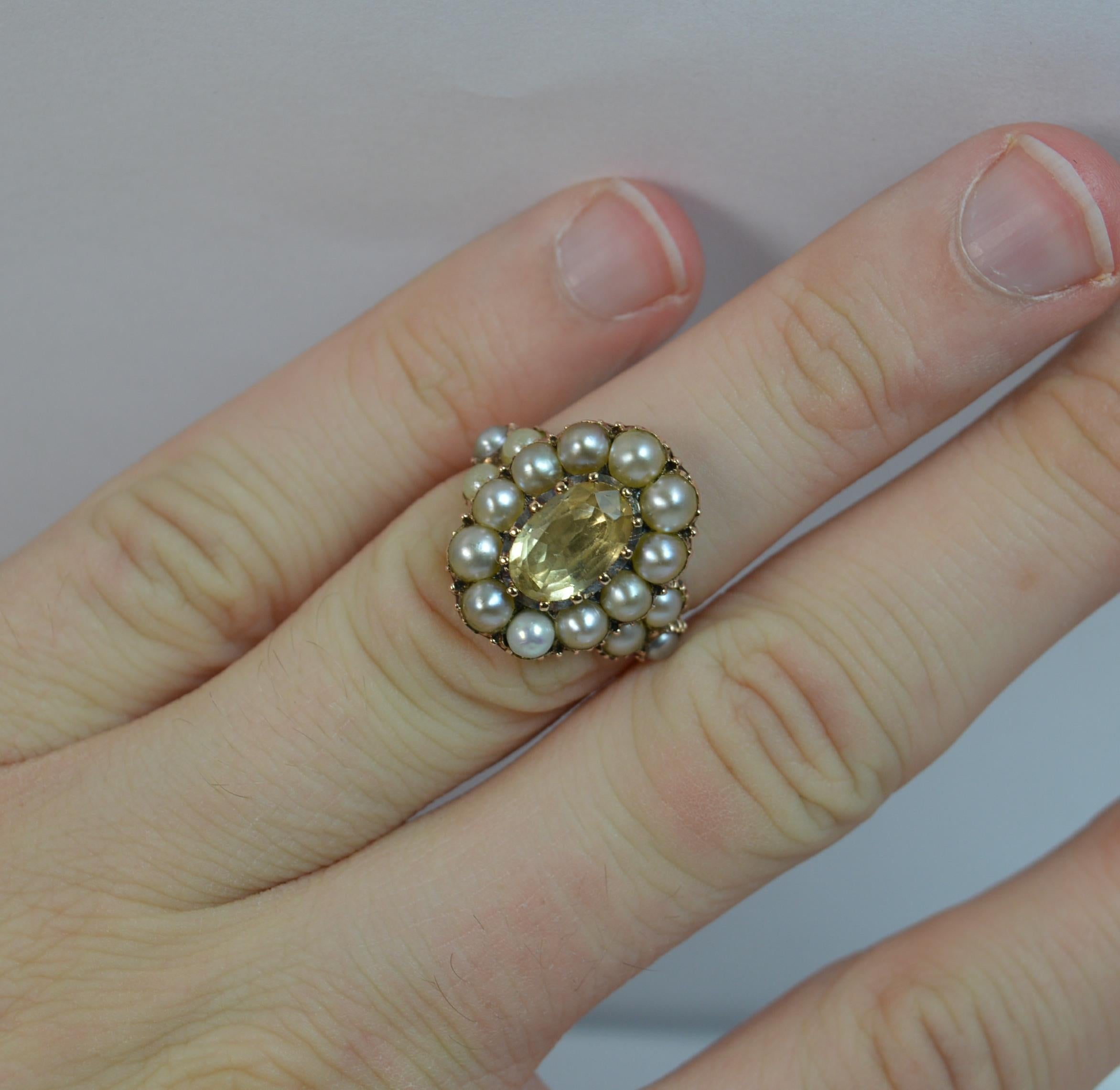 

A Georgian period ladies ring ring. Solid 15ct gold ring.

Designed with an oval shaped very rare yellow topaz to the centre. 6mm x 10mm.

Surrounding the topaz are twelve seed pearls to create a 12.5mm x 17.5mm head. To each shoulder are a