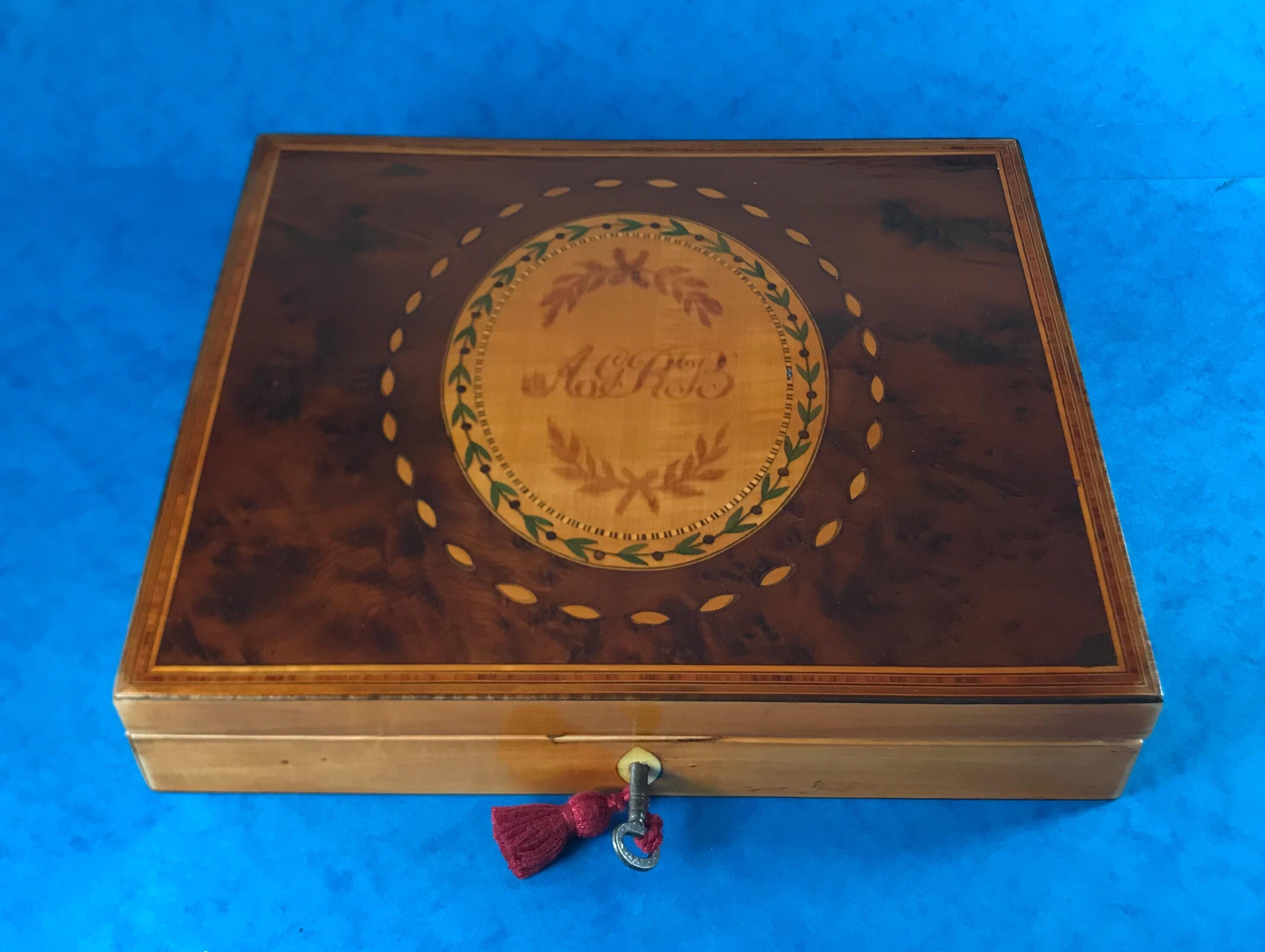 A George III 1785 Sheraton Burr yew hexancgle sycamore stationary box, it has a sycamore panel to the centre which is Harewood and sycamore inlaid, it’s boxwood and tulip wood crossbanded and inlaid around the edge of the box. The lock has bowed