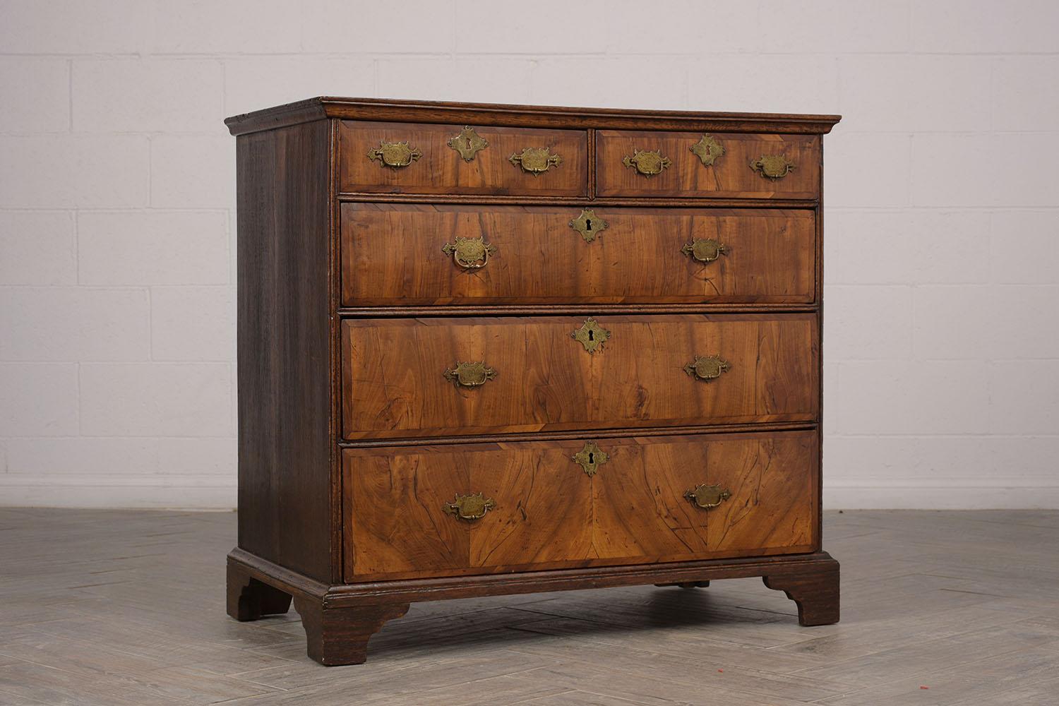 Antique chest of drawers from the 1840s. Made from Walnut wood that features the original mid tone color finish. Features, two top side by side small drawers, followed by three larger drawers, all drawers have dual iron design handles with