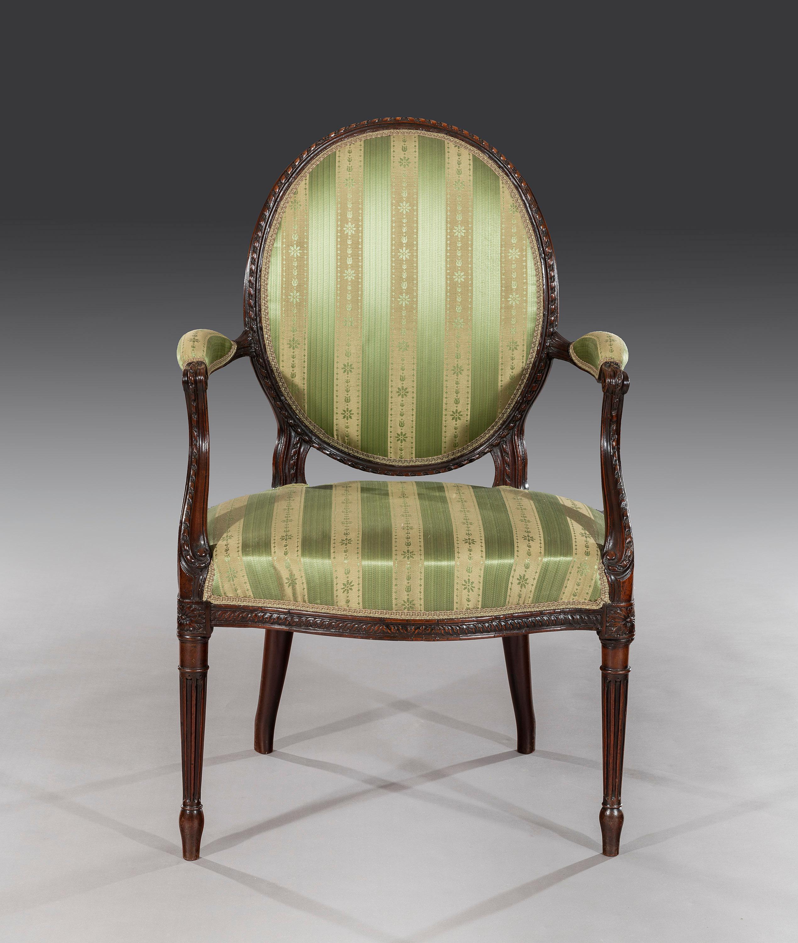 The elegant chair is carved throughout and has recently been re-covered in patterned green silk fabric.

Measures: Seat height 44.00 cm.