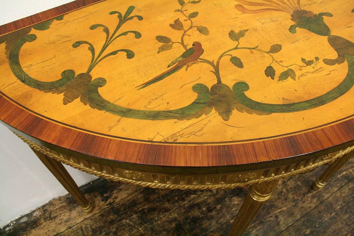 George III Adams style satinwood, rosewood and kingwood inlaid demilune side table, circa 1775 (and later). The table has kingwood banded top, and inside this is satinwood and rosewood banding. The table is profusely inlaid with wonderful foliate