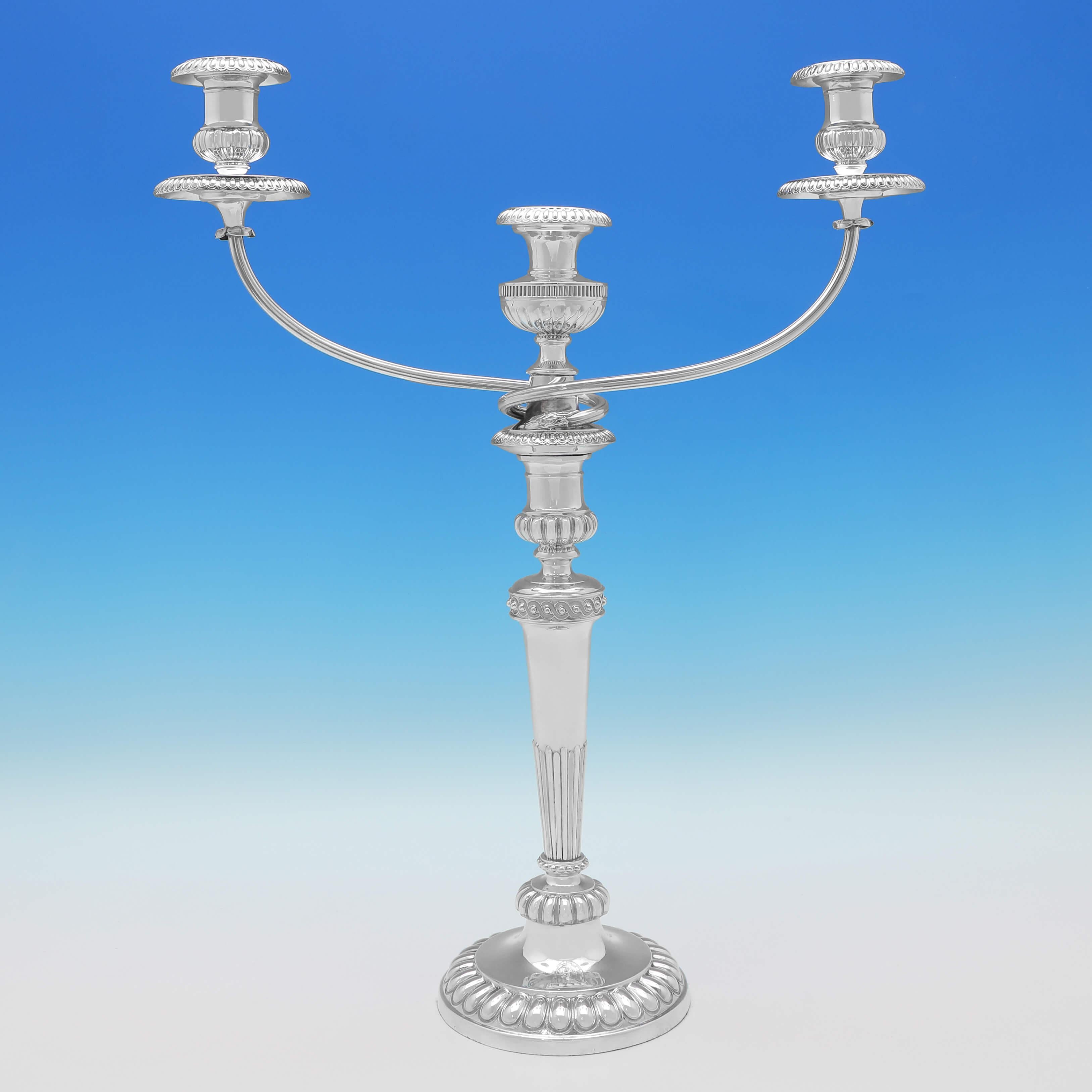 Hallmarked in Sheffield in 1807 & 1808 by John Roberts & Co., this striking, George III, pair of Antique Sterling Silver Candelabra, are in the Regency taste, with acanthus and gadroon detailing, engraved crests, and will hold three candles. Each