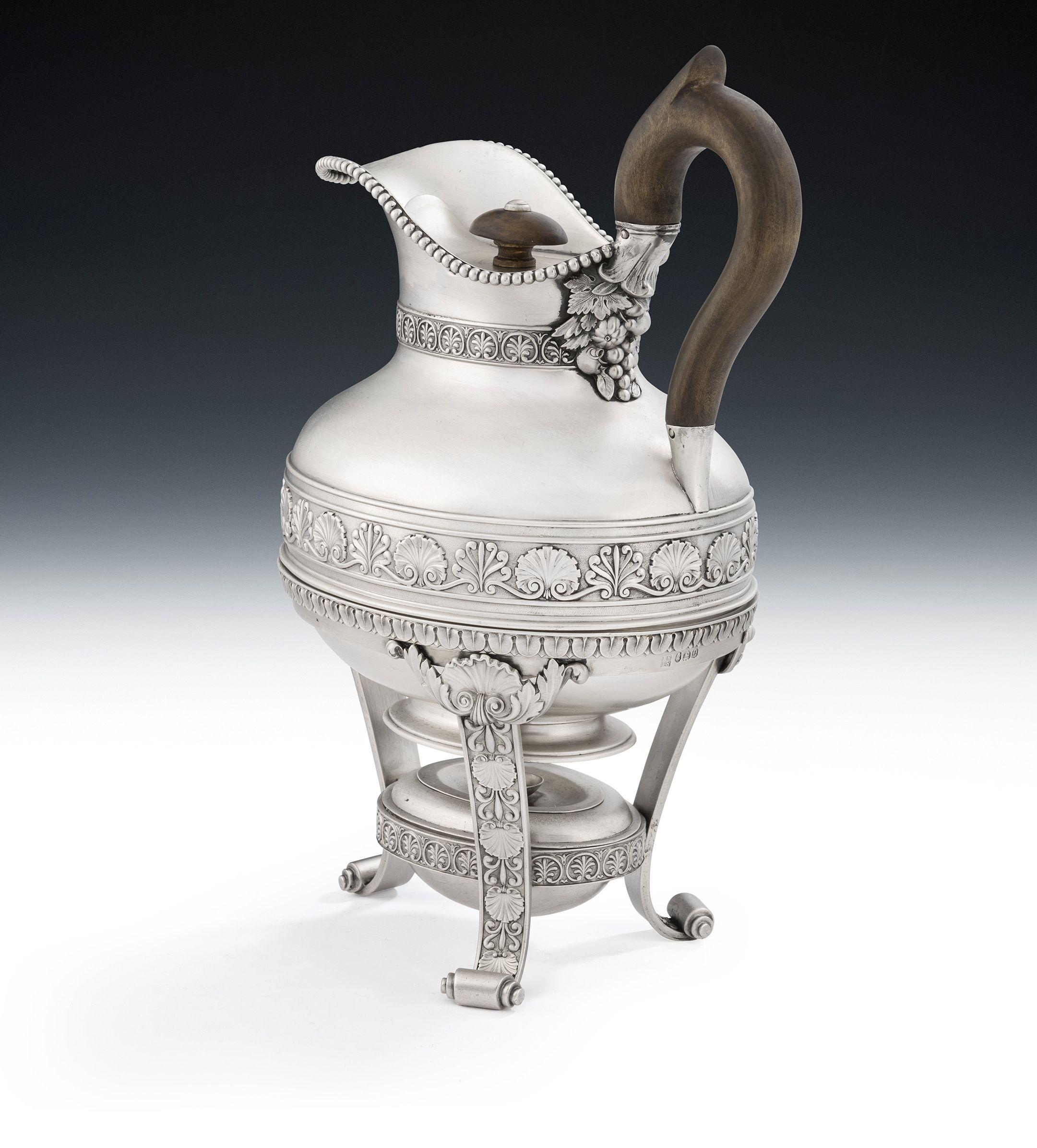 A very fine and unusual George III Biggin on Lampstand made in London in 1811 by the Royal silversmiths, Benjamin & James Smith.

The Jug is of compressed egg shaped form with an applied beaded rim.  The neck is cast and decorated with palm motifs,