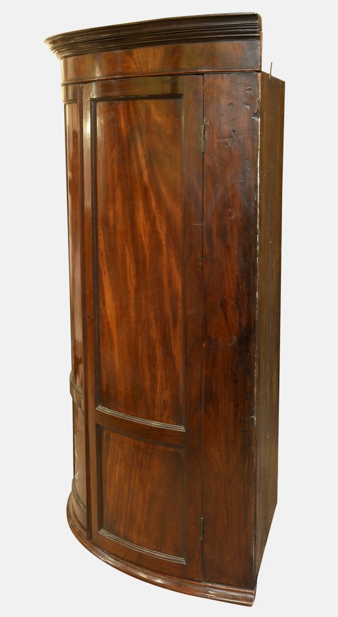 A George III bow fronted figure mahogany corner cupboard.

circa 1780.